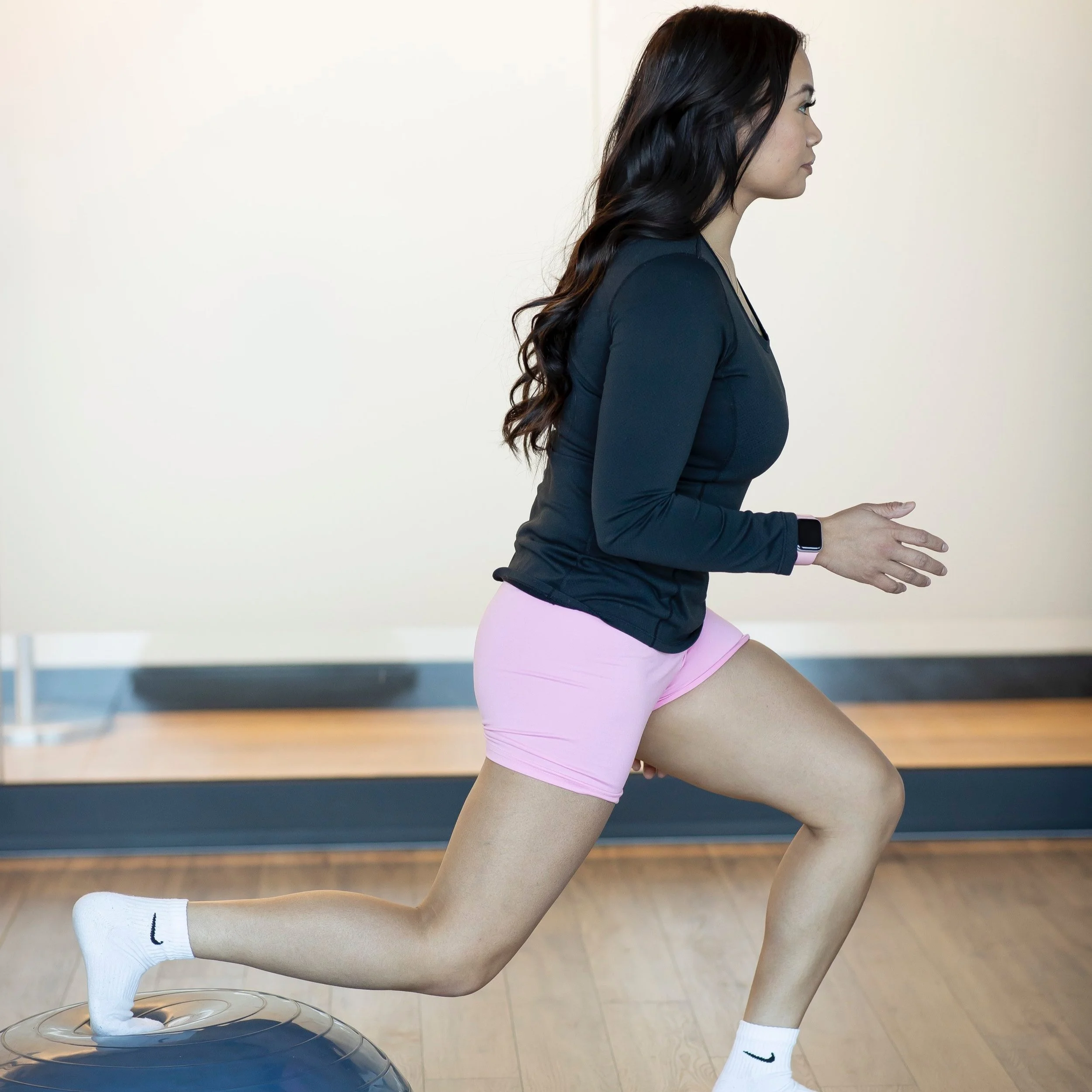 Woman exercising indoors with a stability dome