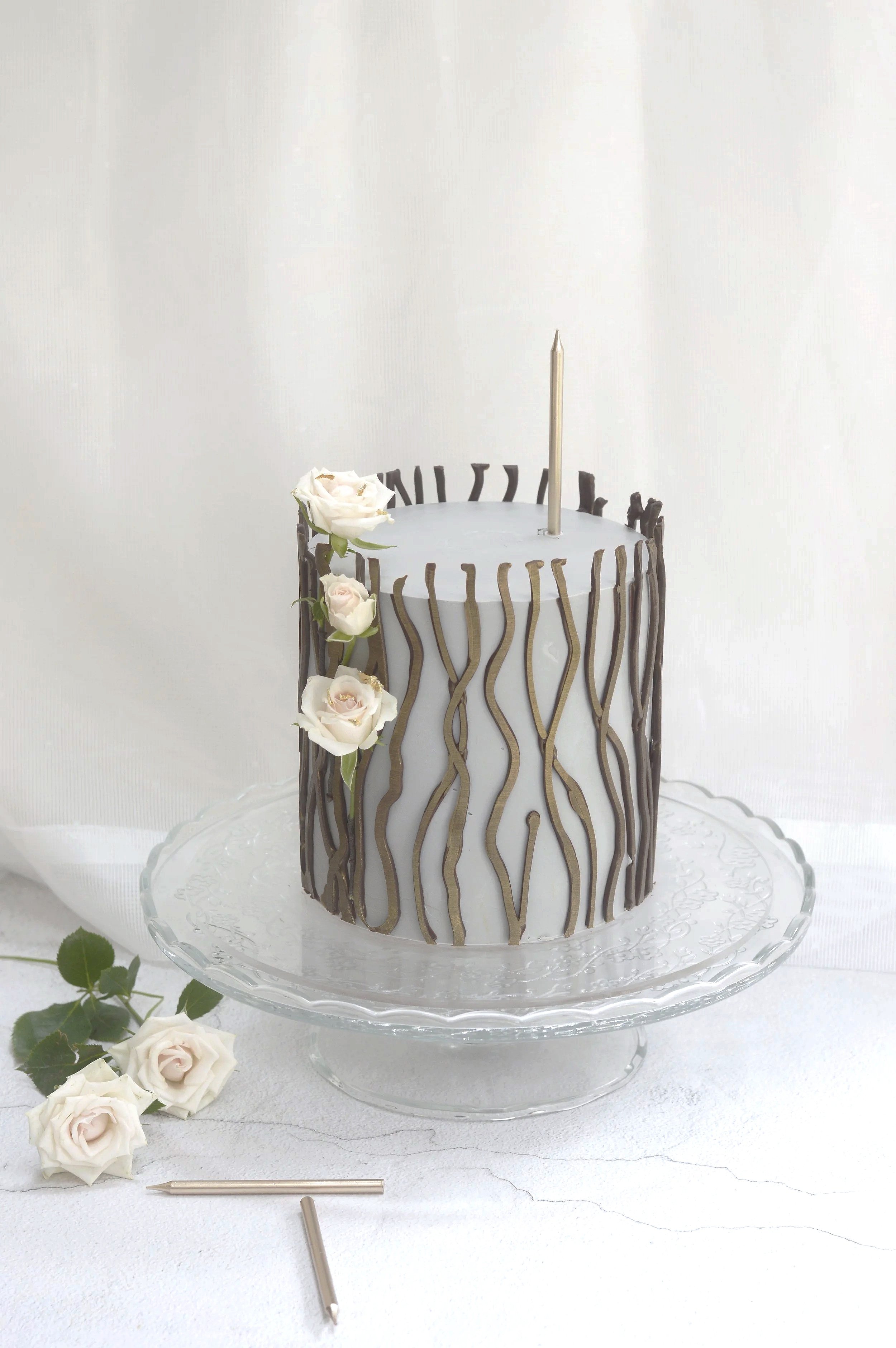 Elegant bespoke celebration cake with refined buttercream finish and chocolate decorations, Manchester