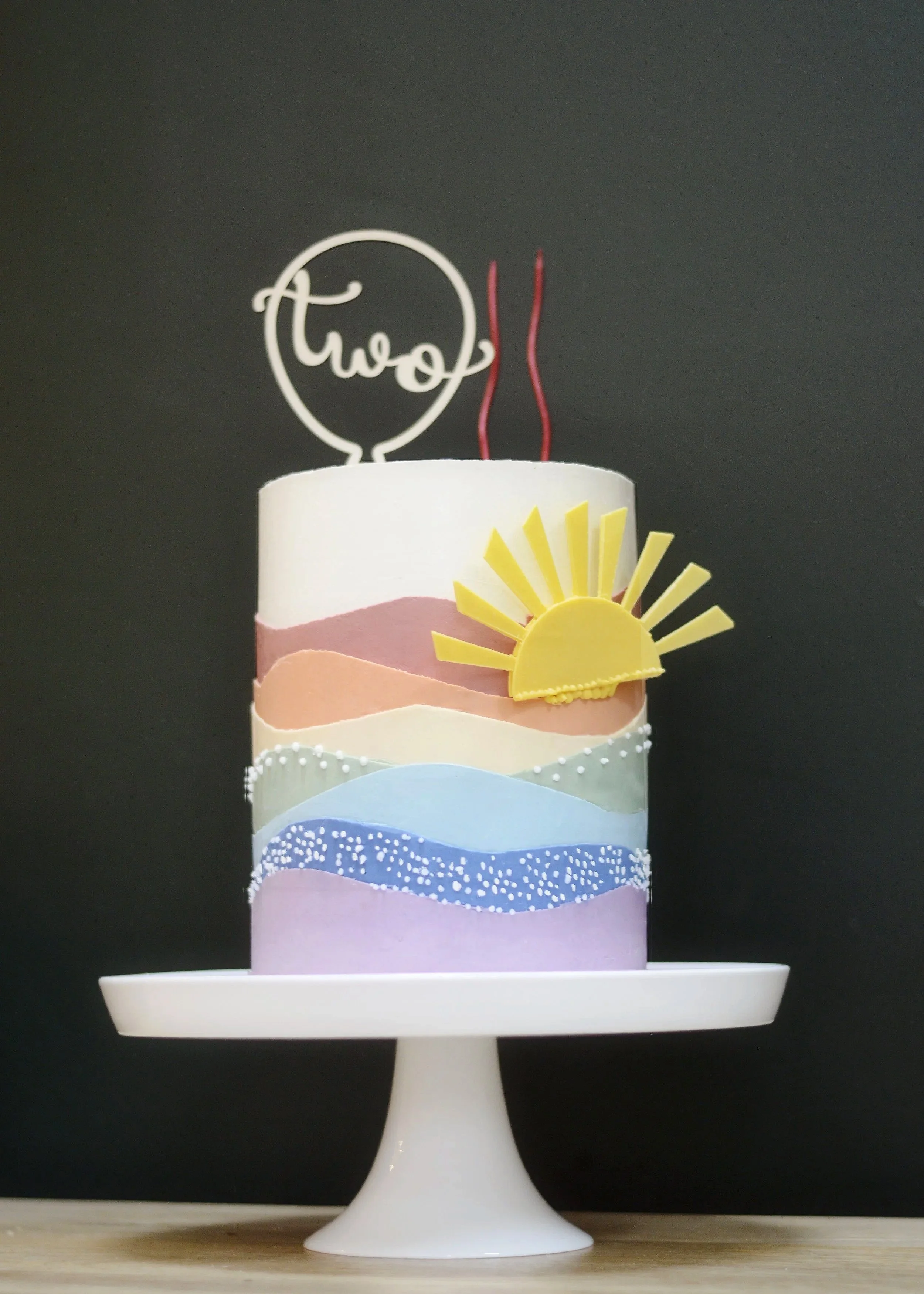 Elegant handmade celebration cake with minimalist decoration, colourful rainbow themed cake,  Cheshire