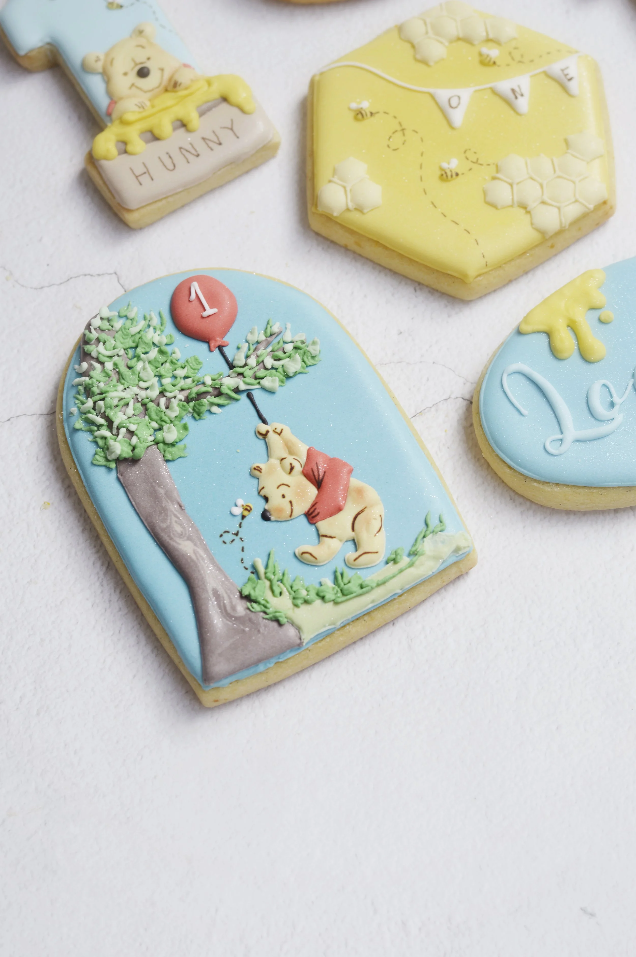 Hand-decorated personalised sugar cookies for a first birthday