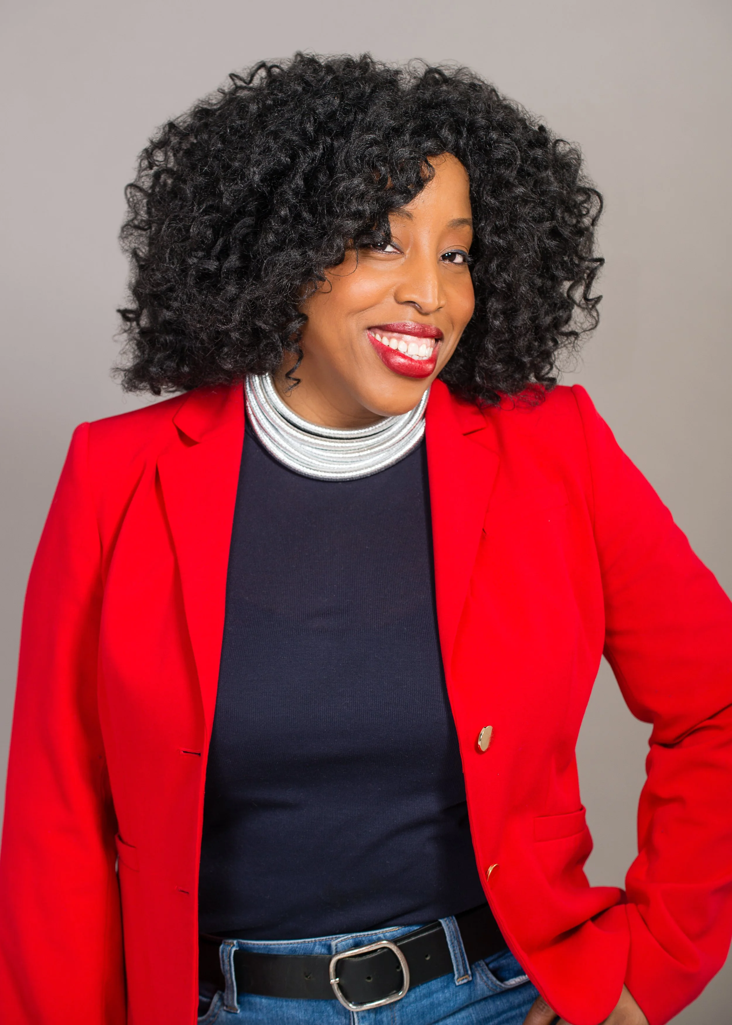 Lillian Ogbogoh, a black woman in red jacket