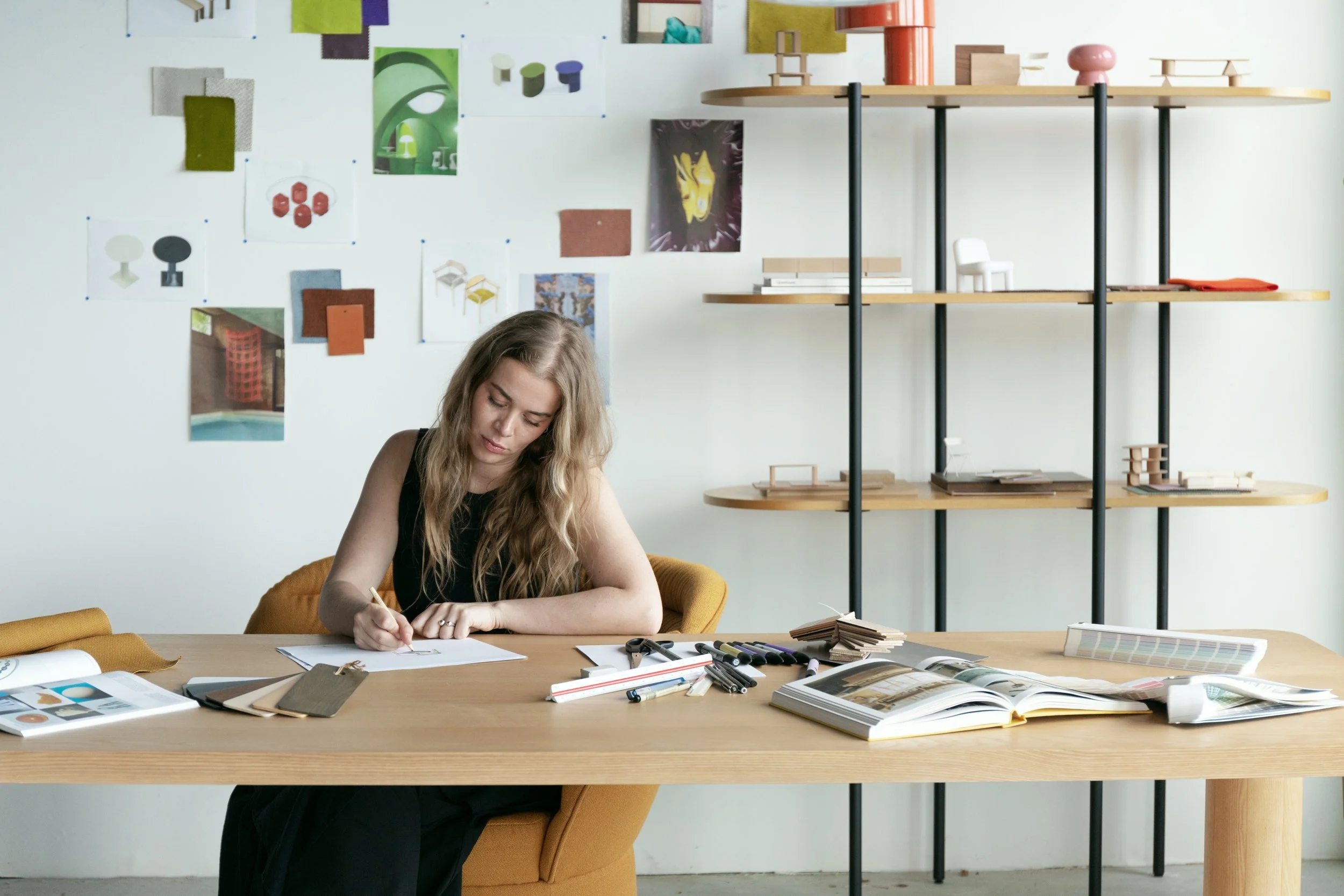 Simone Smelt sketching on a table in her design studio in Amsterdam
