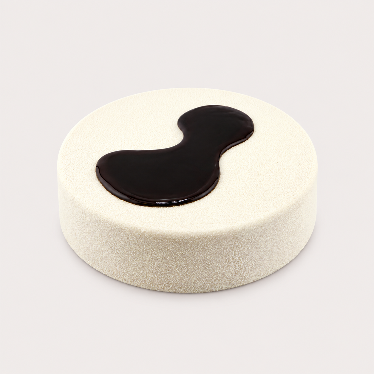 Minimal white GIOMECCA cake with a dark chocolate glaze detail