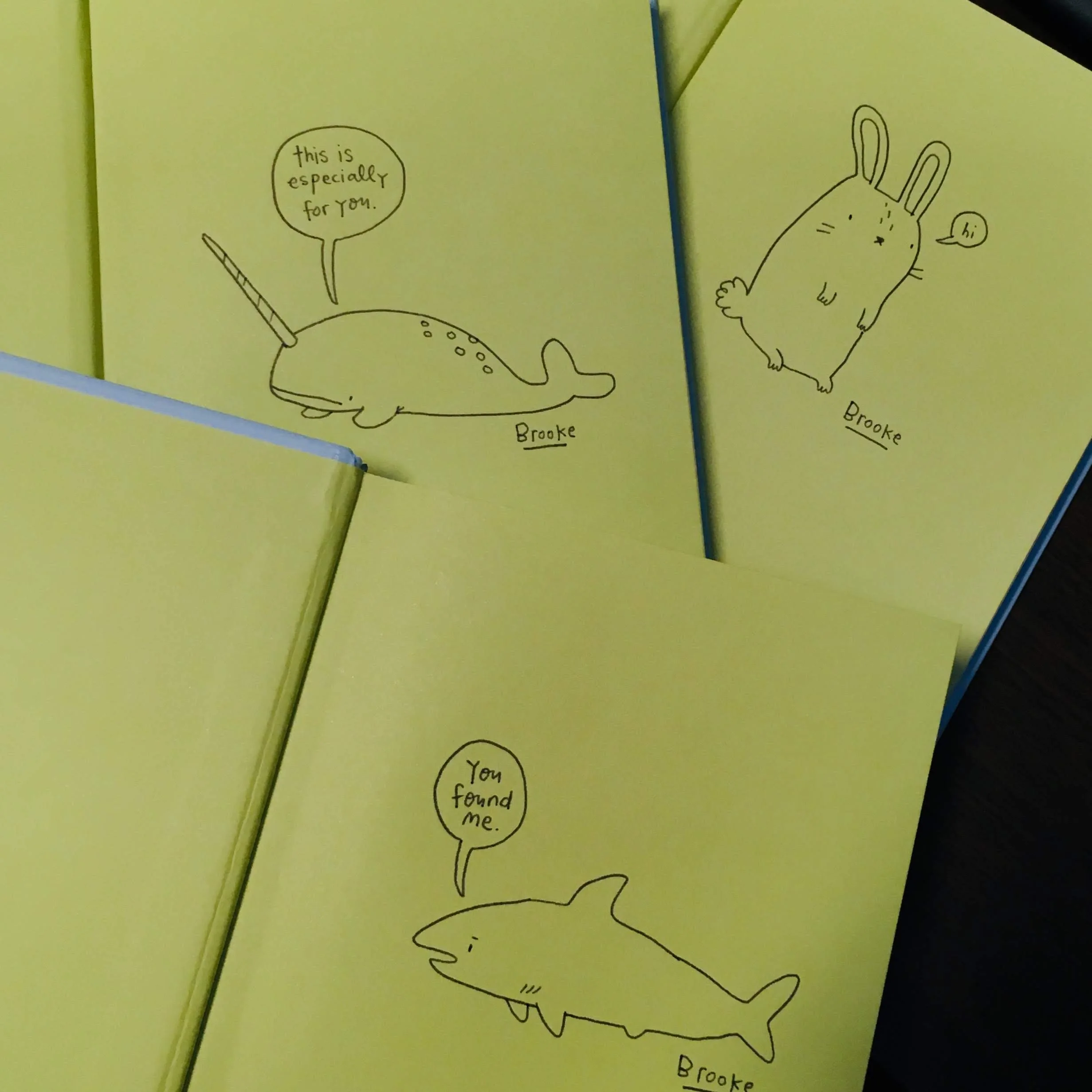 Yellow cards with doodles by "Brooke," featuring a narwhal saying "this is especially for you," a rabbit saying "hi," and a shark saying "You found me."