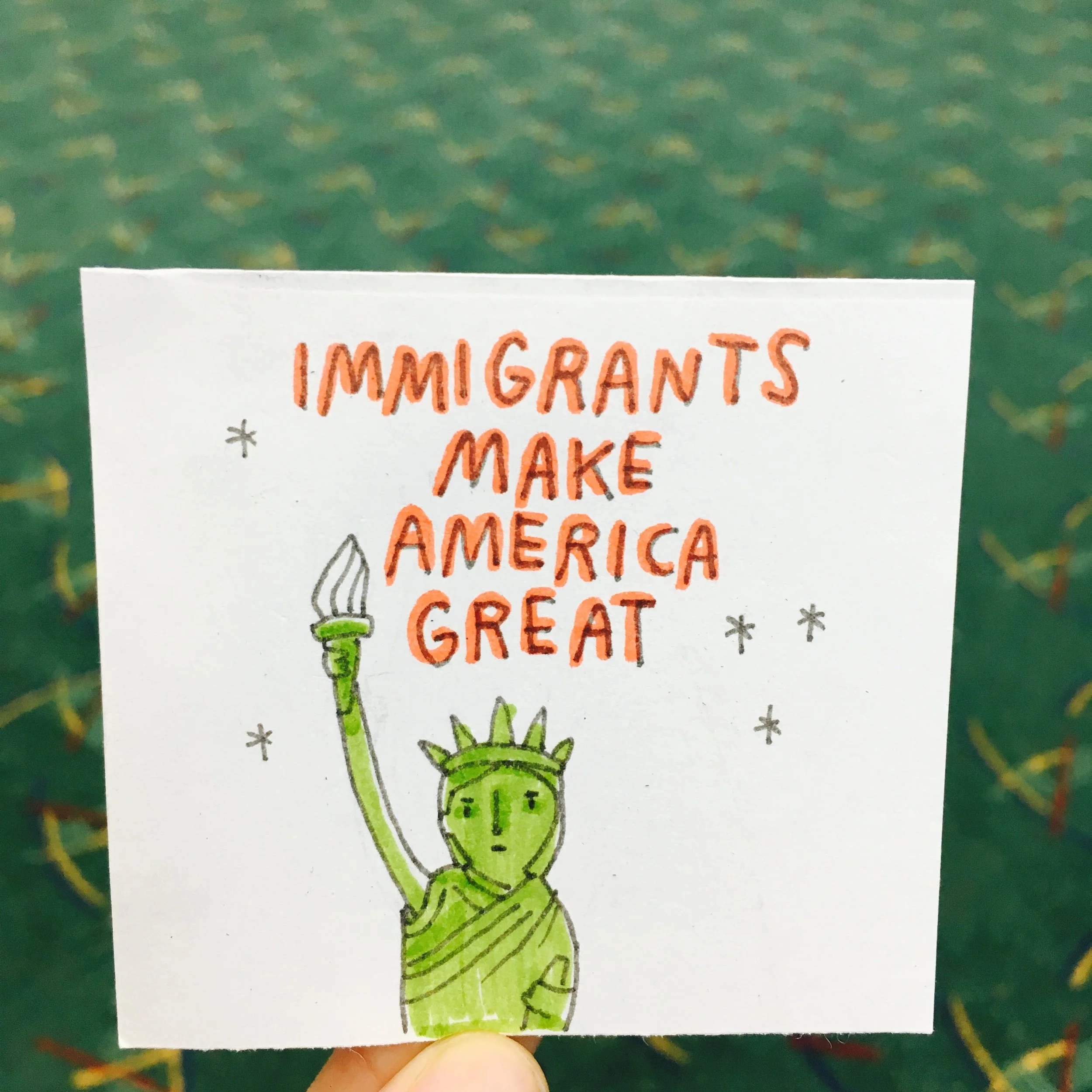 Hand-drawn illustration with the phrase 'Immigrants Make America Great' and a simple sketch of the Statue of Liberty.