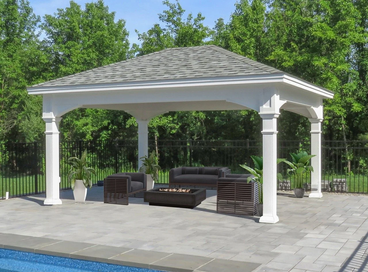 Outdoor poolside patio with a white pavilion, black seating, a fire pit, and potted plants, with green trees in the background.