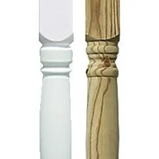 Close-up of two wooden furniture legs, one painted white and the other natural wood finish, with decorative carved details.