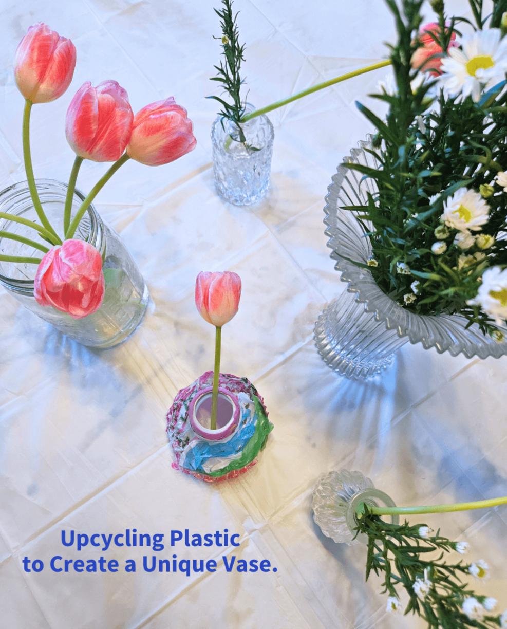 Photo of flower and upcycled plastic vase in art class