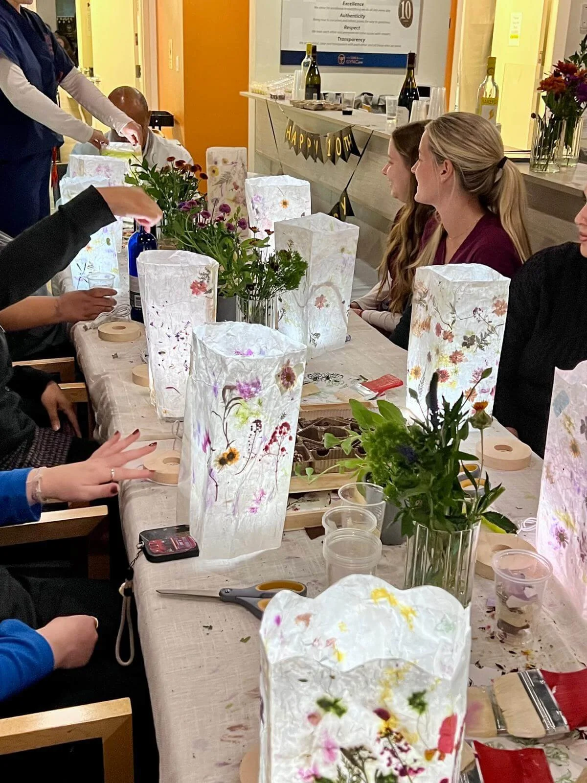 Children playing with a large cardboard house and a tiered play cake decorating arts and craft for a custom birthday art event