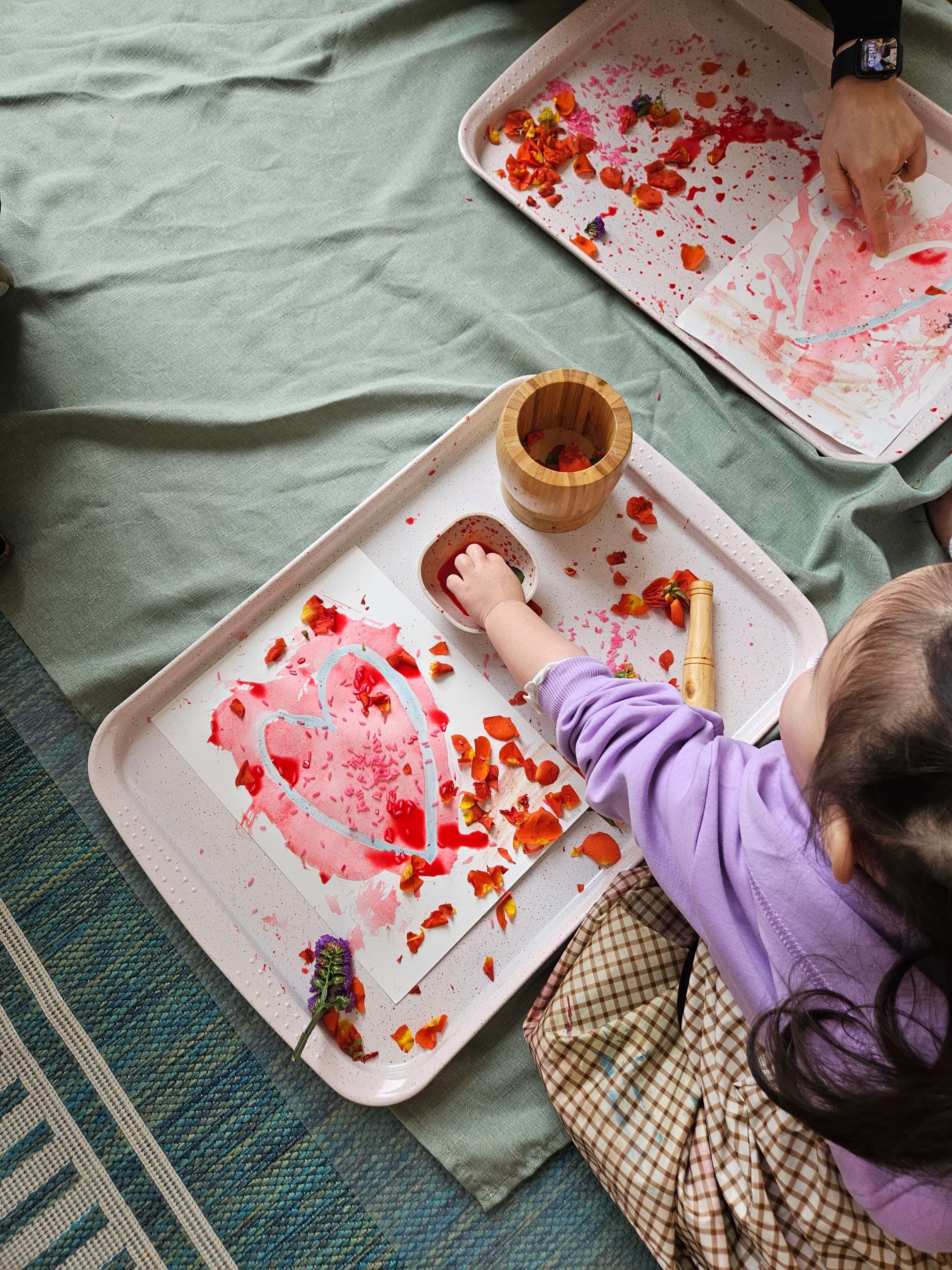 A child adds color and flower petals to a heart artwork during a hands-on Mini Makers art activity in Fort Lee, NJ.