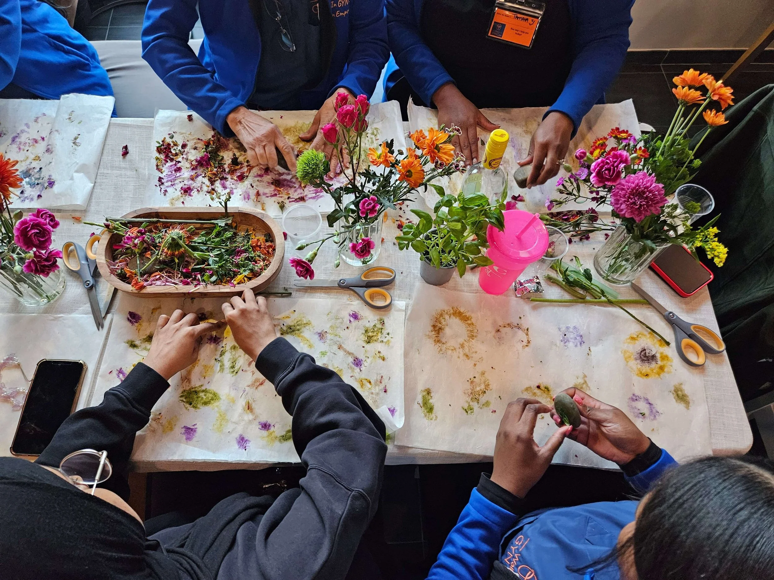 photo of adults and kids doing art with flowers