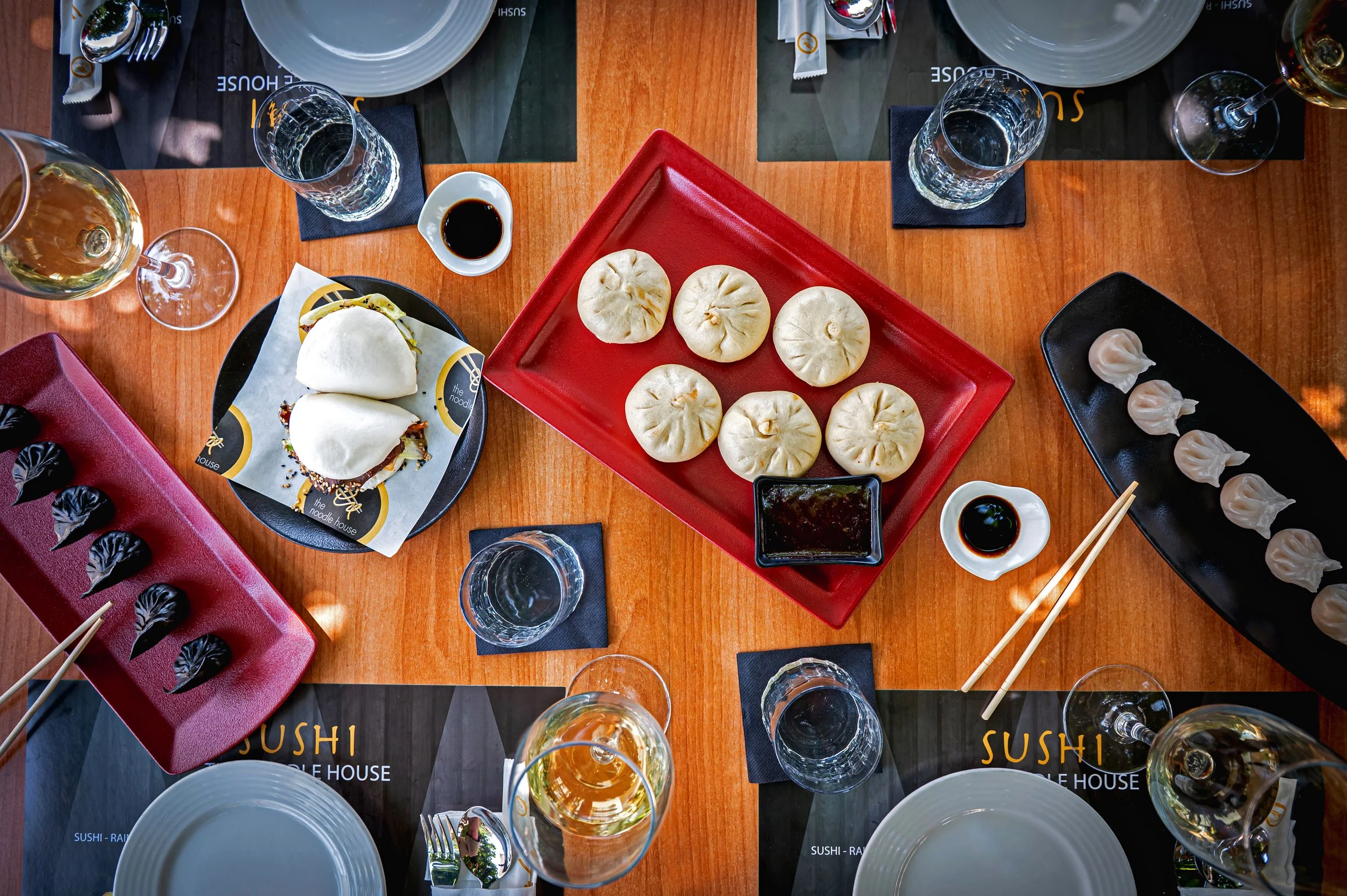 Assorted sushi rolls on a wooden board with ginger and wasabi garnish.