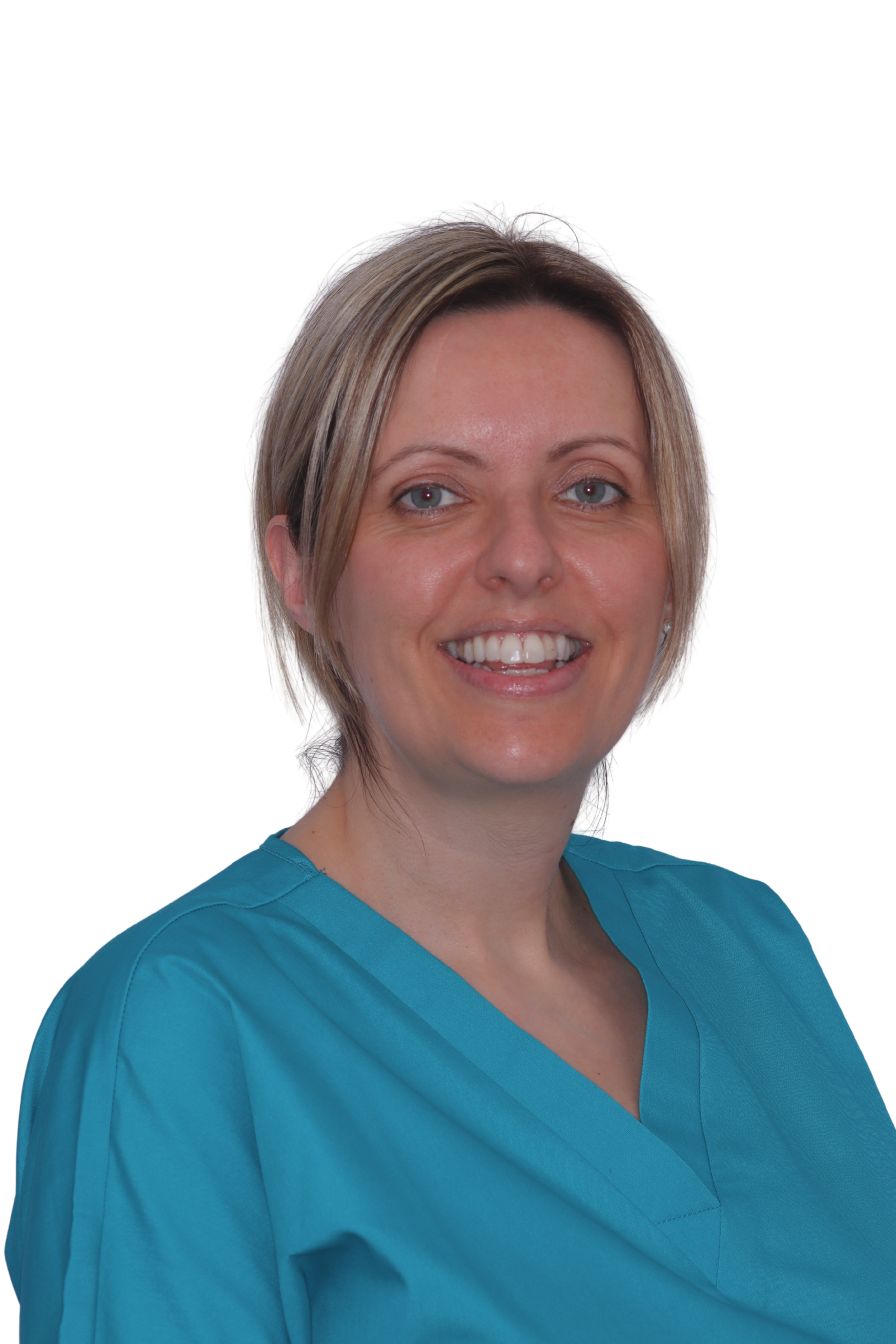 Smiling woman in teal scrubs with brown hair