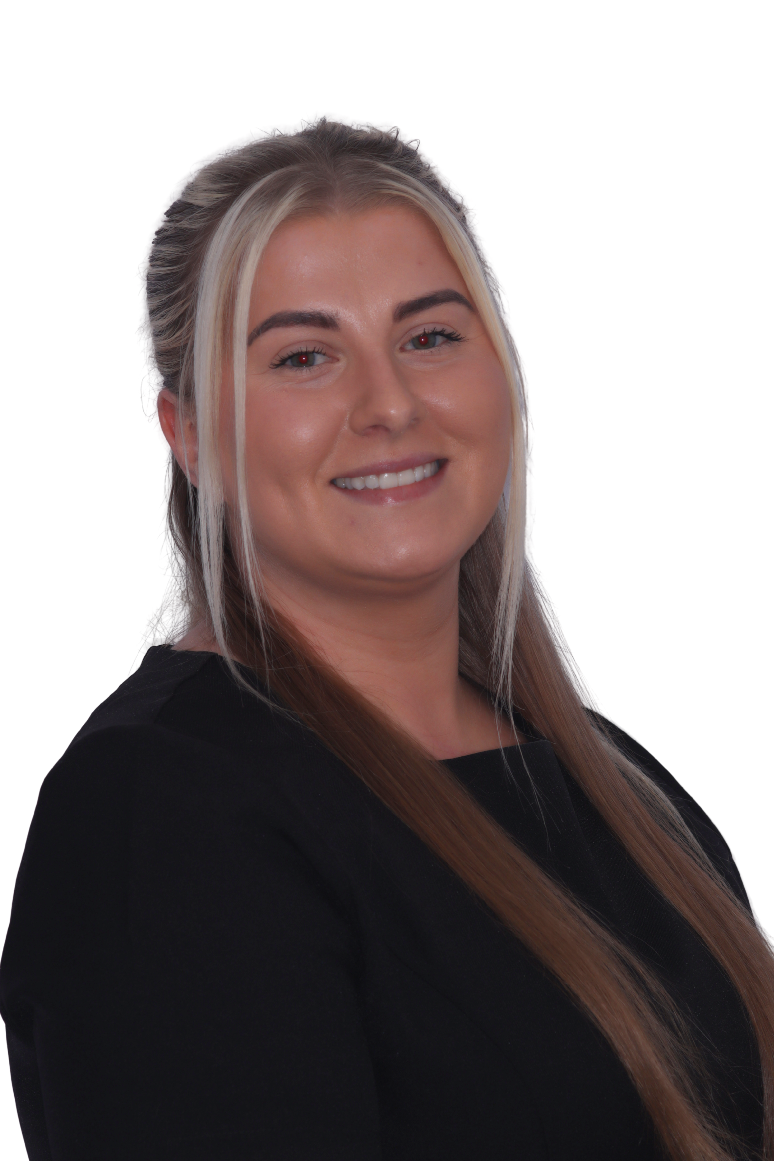 Person in turquoise scrubs wearing glasses, smiling