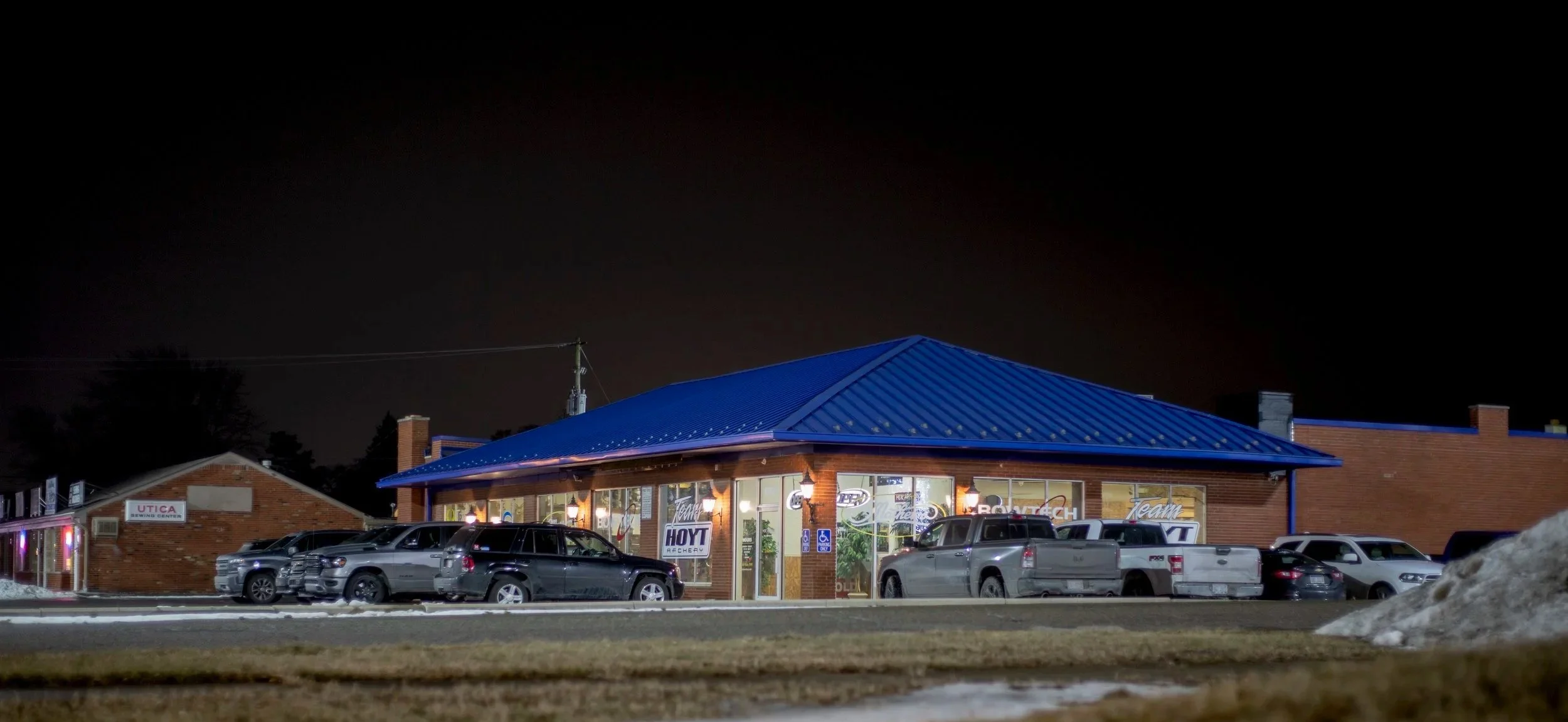 The Kinetic Edge Archery shop on Van Dyke Avenue at night