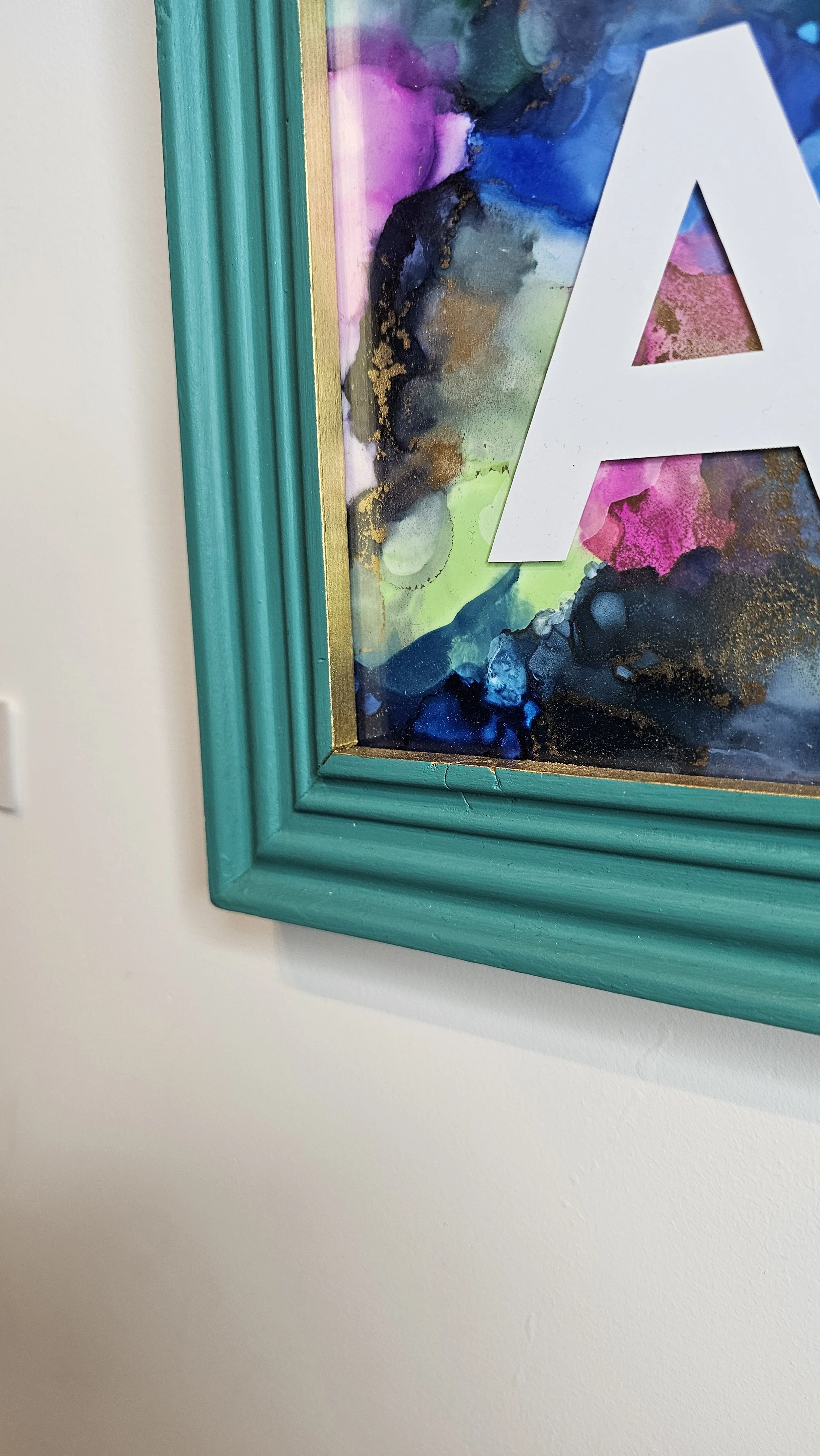 Original alcohol ink art with blue and pink colours. Close up view of gold edging and detailed shot of the upcycled wooden frame