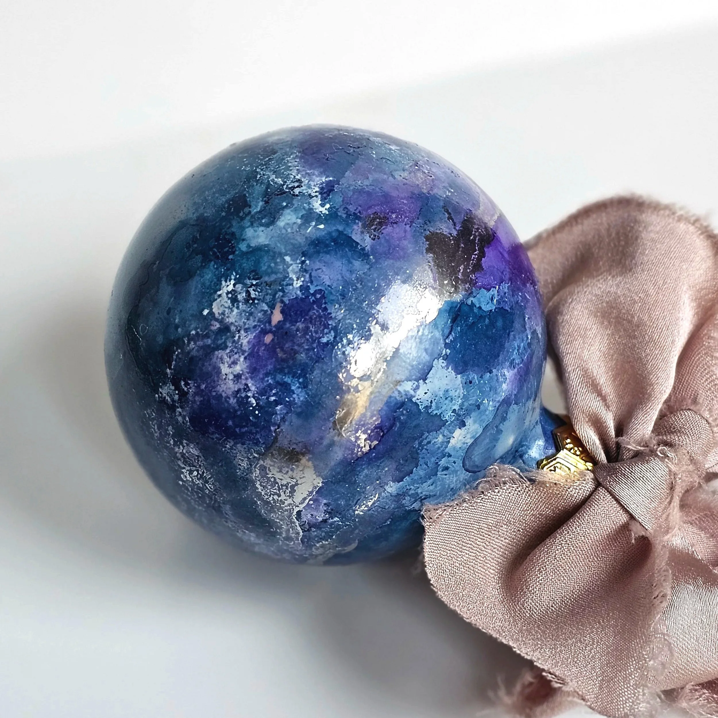 mottled+planet+blue+and+silver+bauble+with+beige+ribbon.jpg