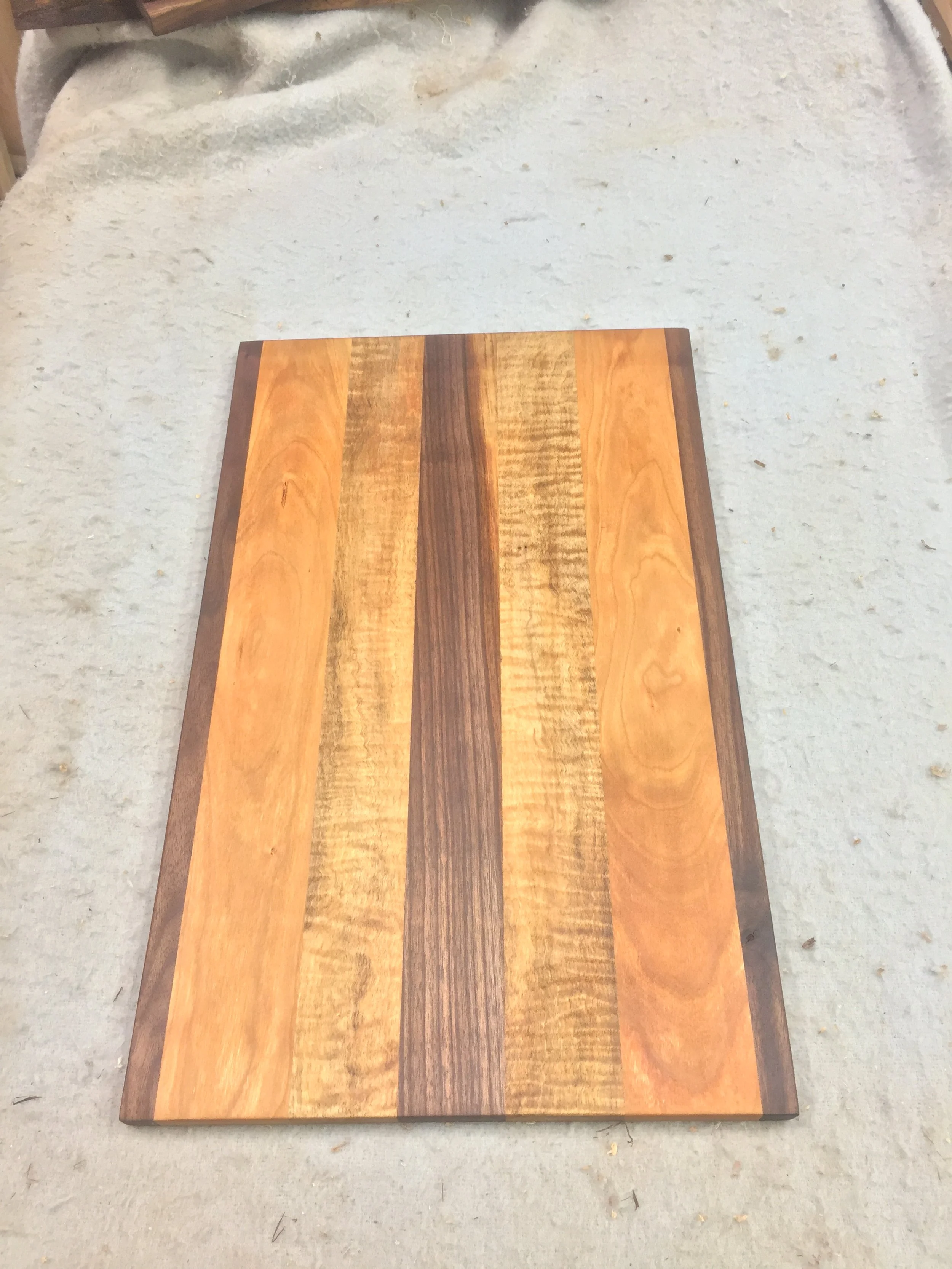 Example project using our Upstate NY hardwood: black walnut, cherry, and tiger maple combined in a custom cutting board.