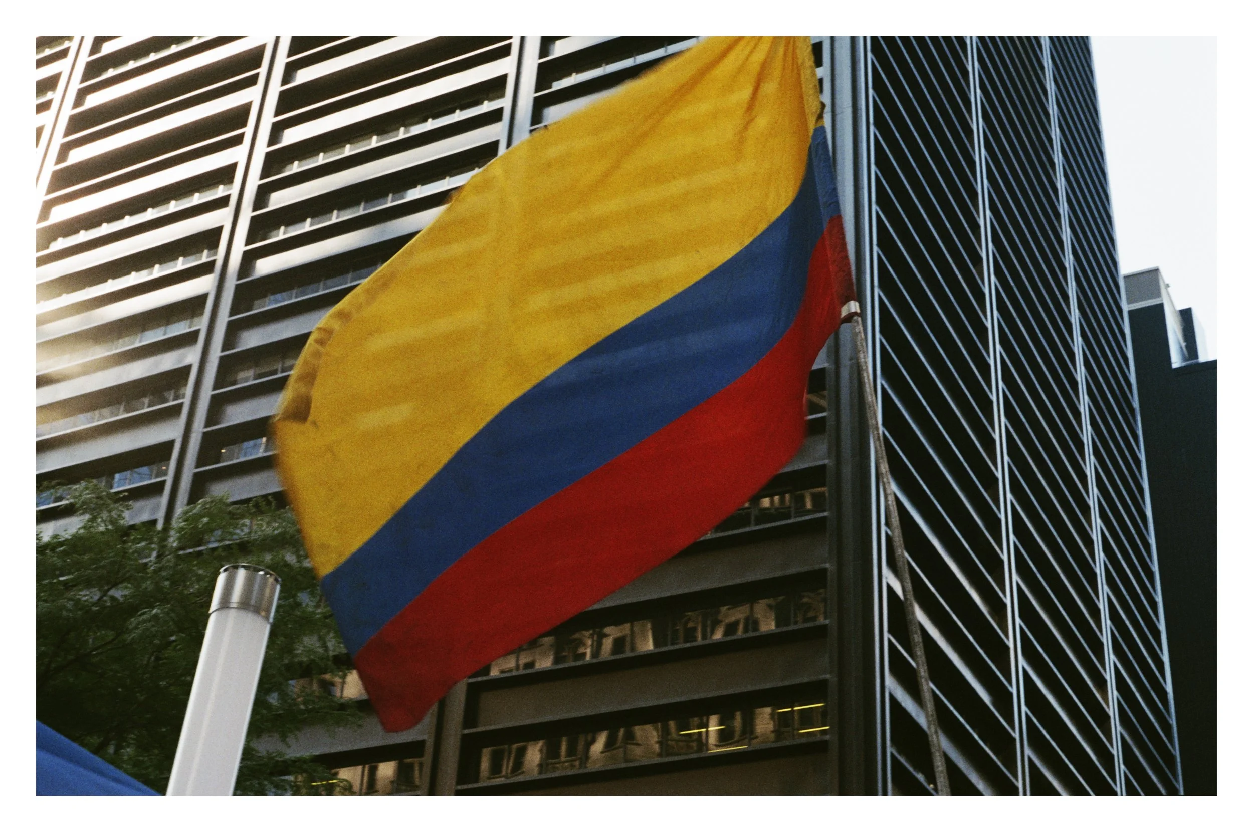 Colombian flag in front of a tall building.