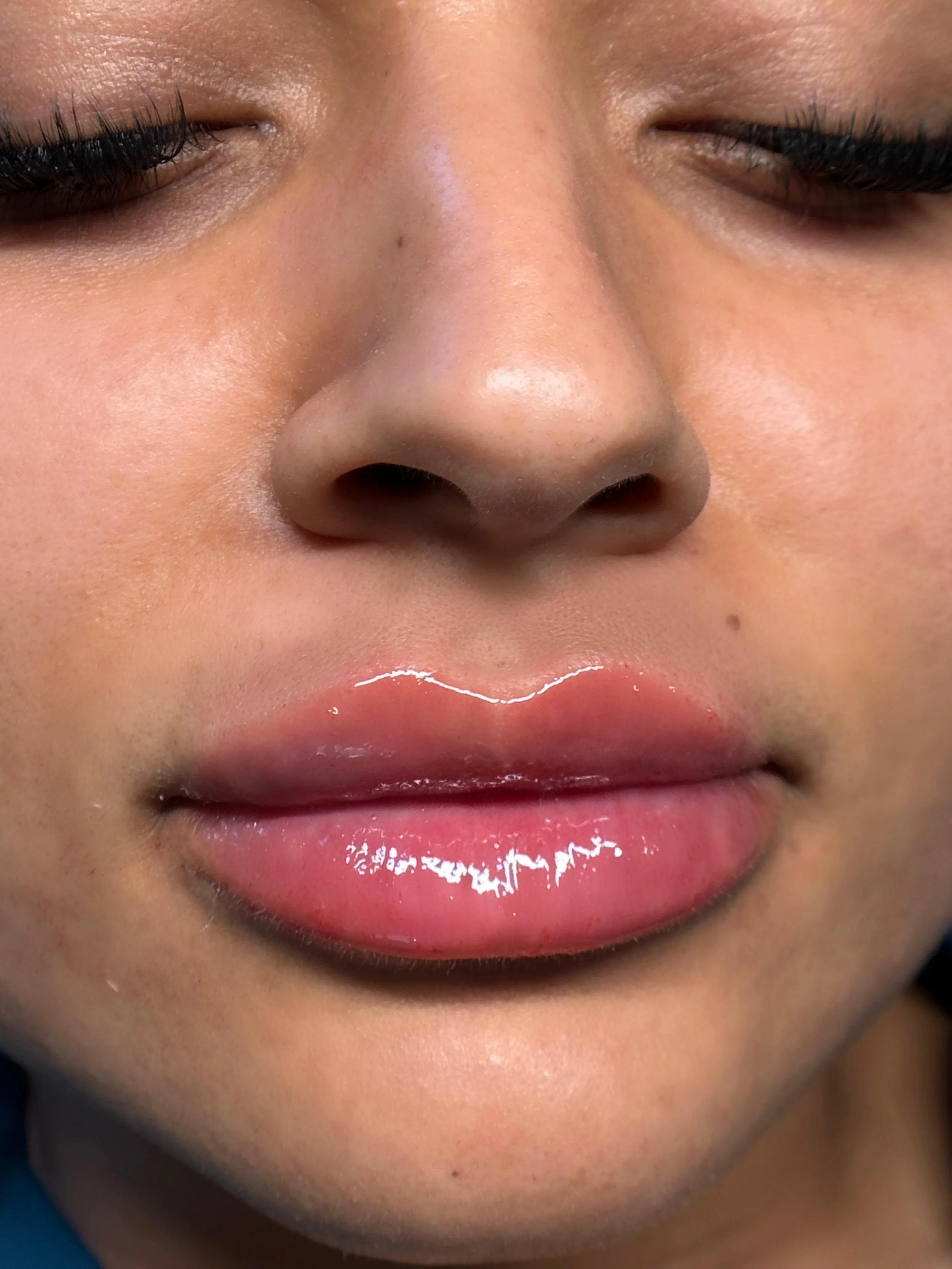 Close-up of a person's face with juicy, full lips.