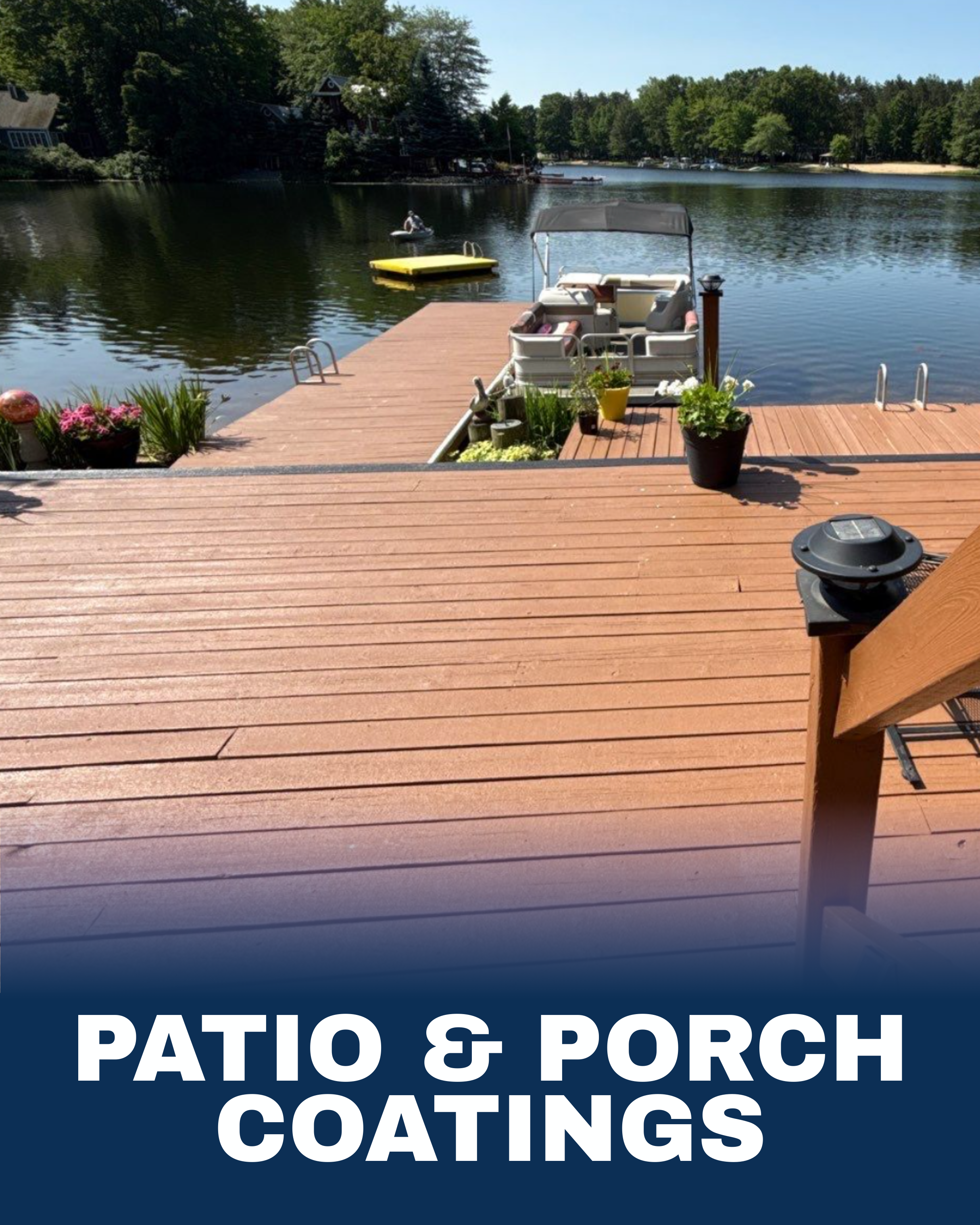 View of a wooden dock by a lake with a pontoon boat, potted plants, and a small boat in the water, surrounded by trees.