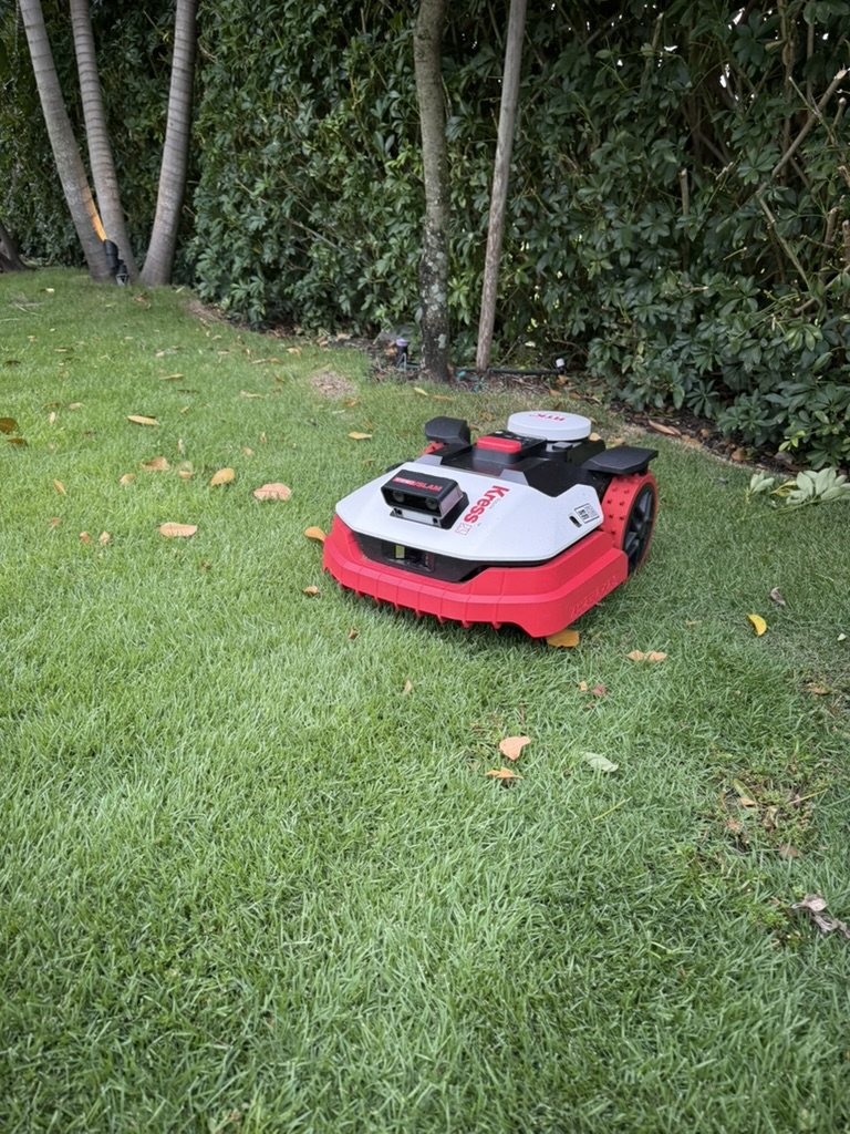 Red Kress robotic mower on a lawn