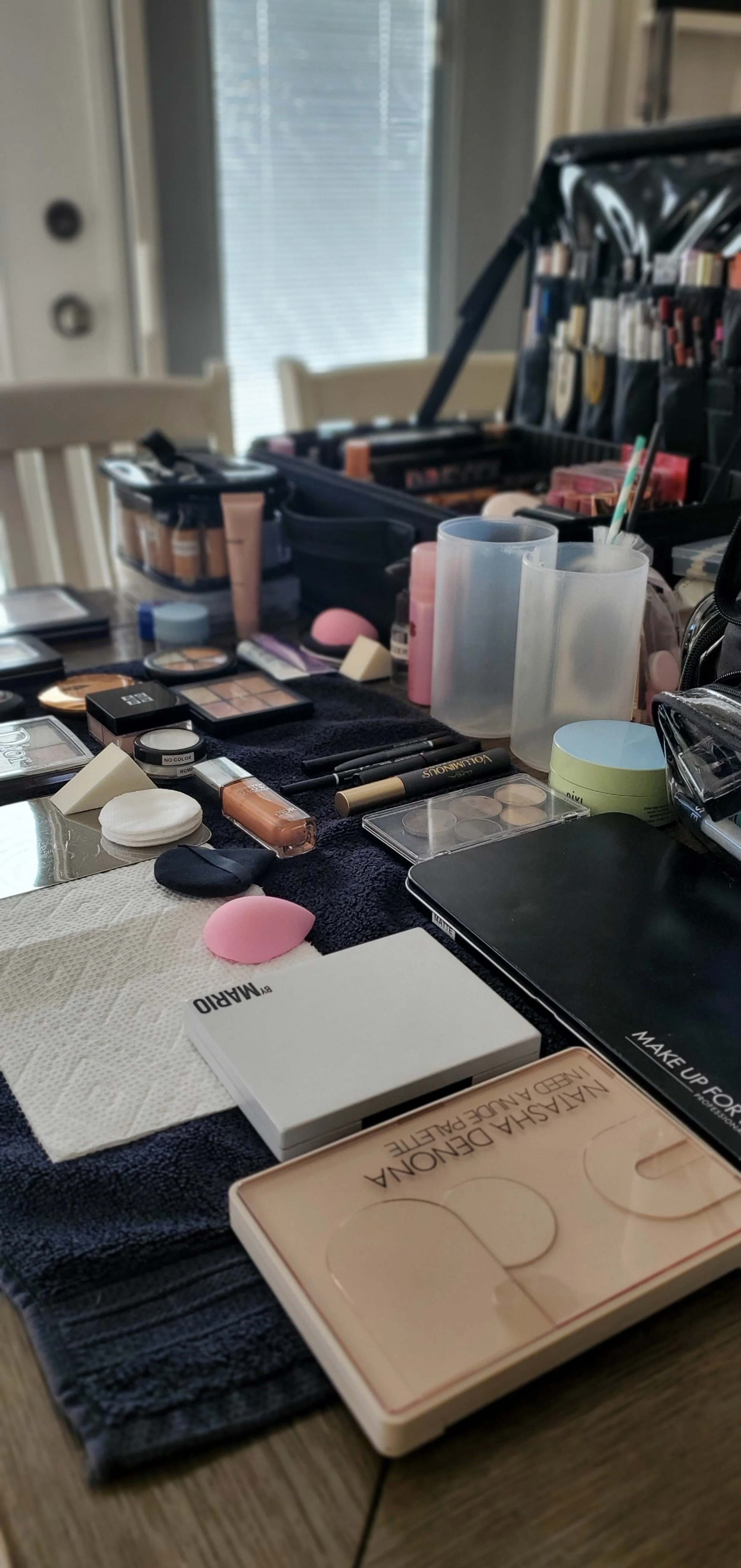 On-location set up with professional makeup kit, brushes, sponges and lighting.