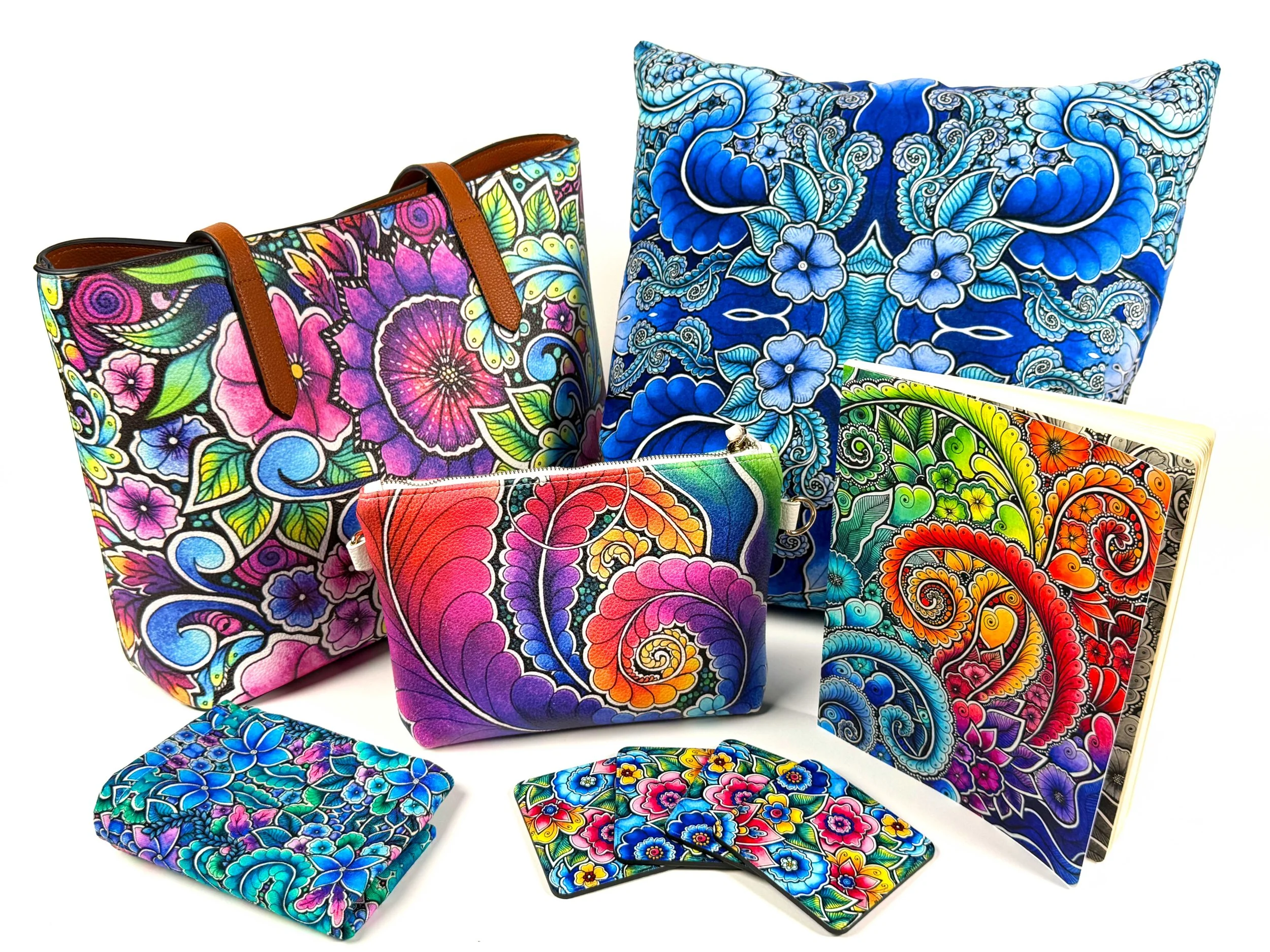 Colorful, psychedelic-patterned bags and pouches with floral and abstract designs arranged against a white background.