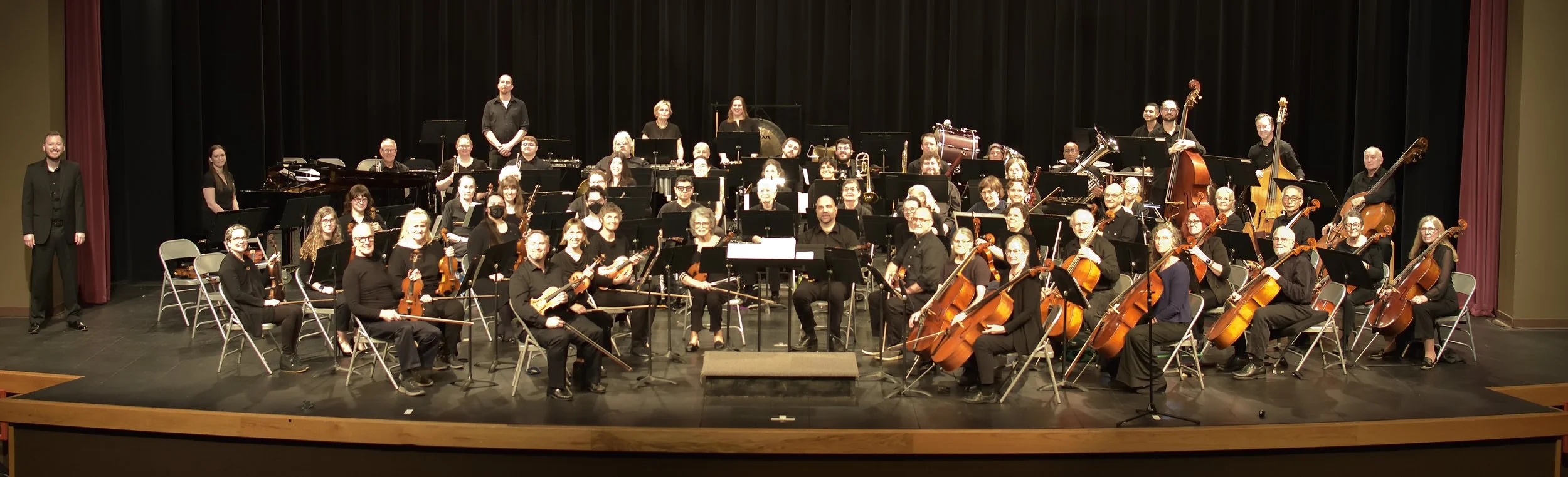Eugene Springfield Community Orchestra seated on stage before performance