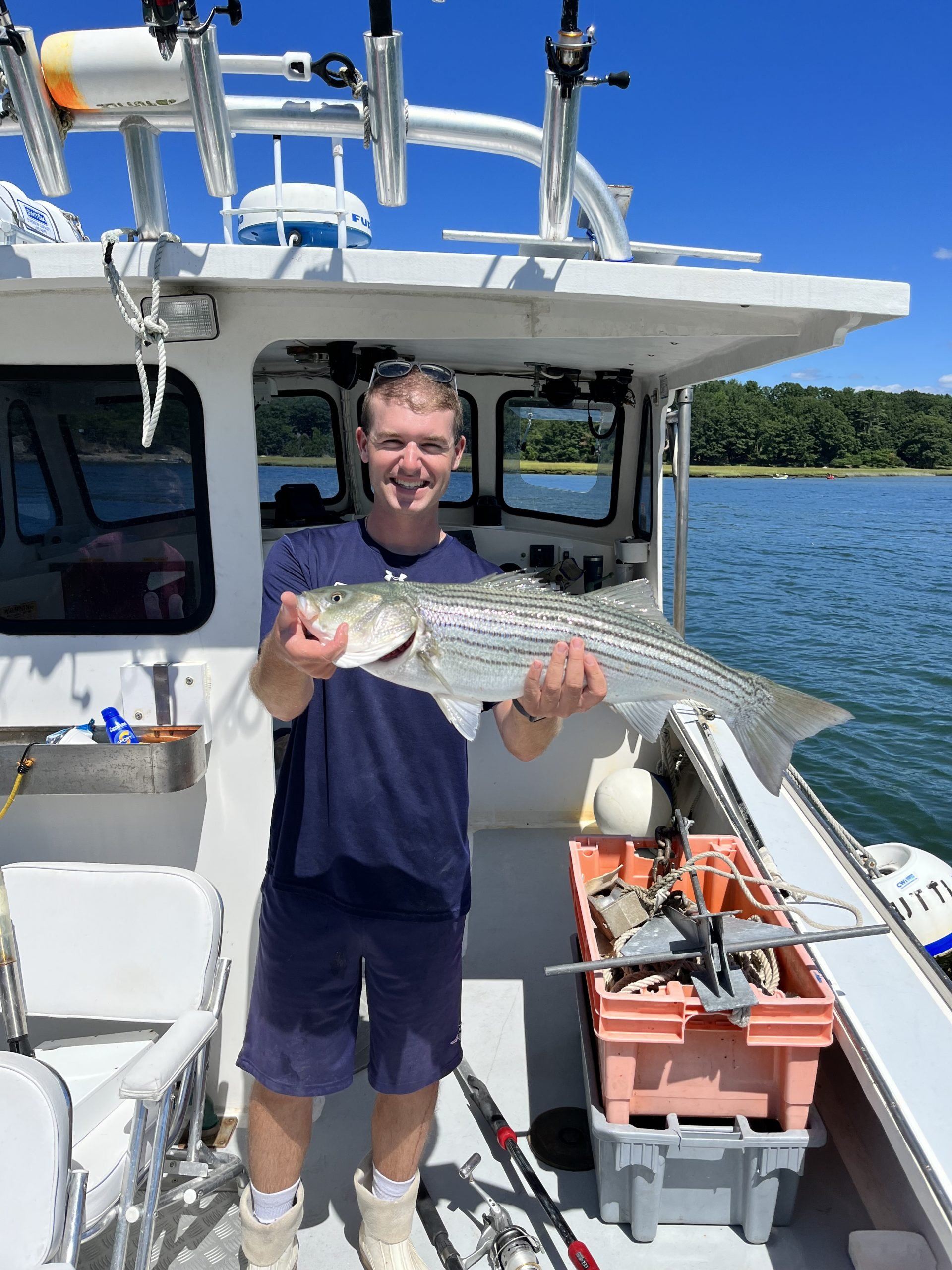 young captain with large fish in the black dog fishing charter boat