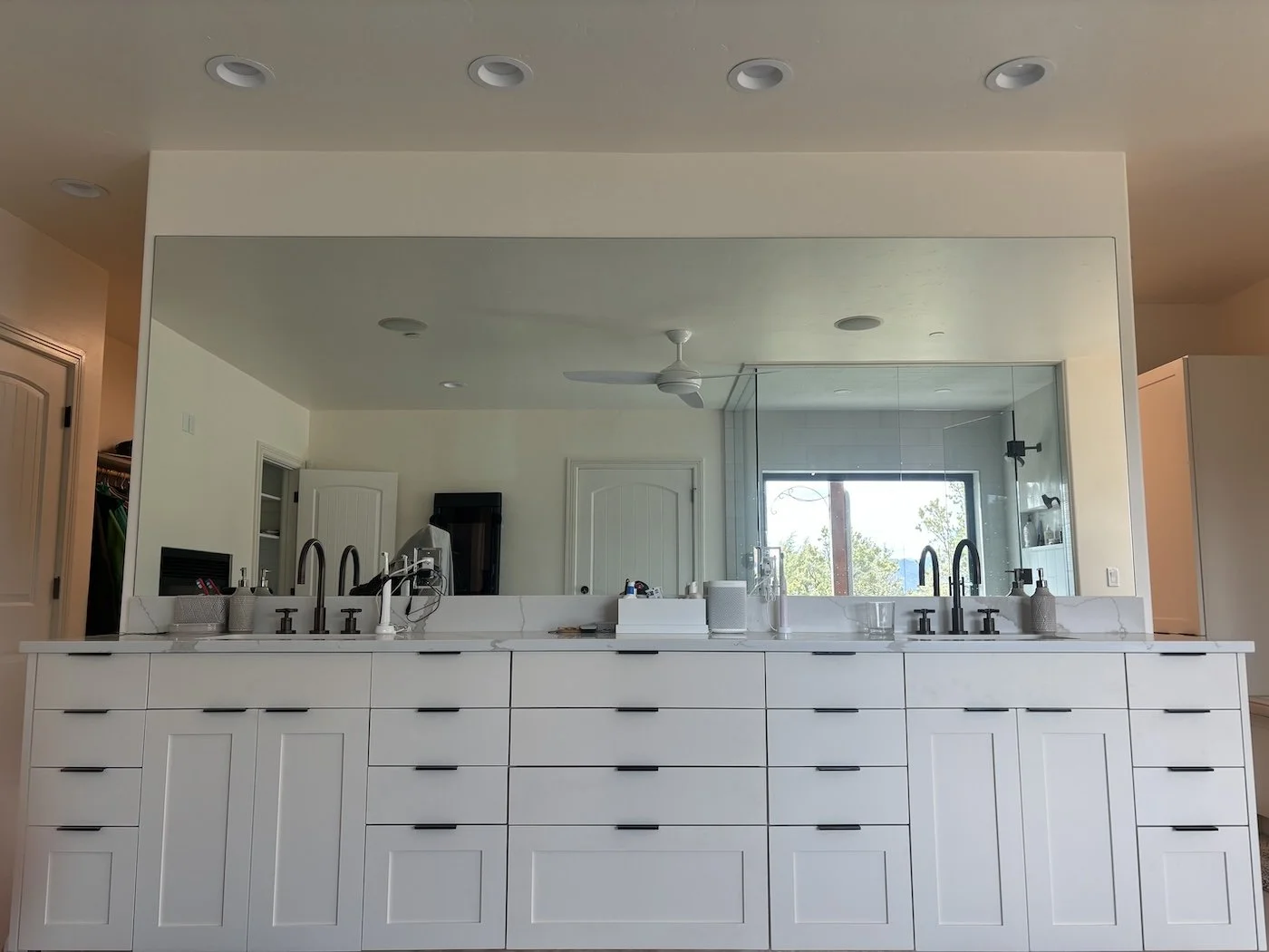 Modern bathroom vanity with dual sinks, large mirror, and cabinetry.