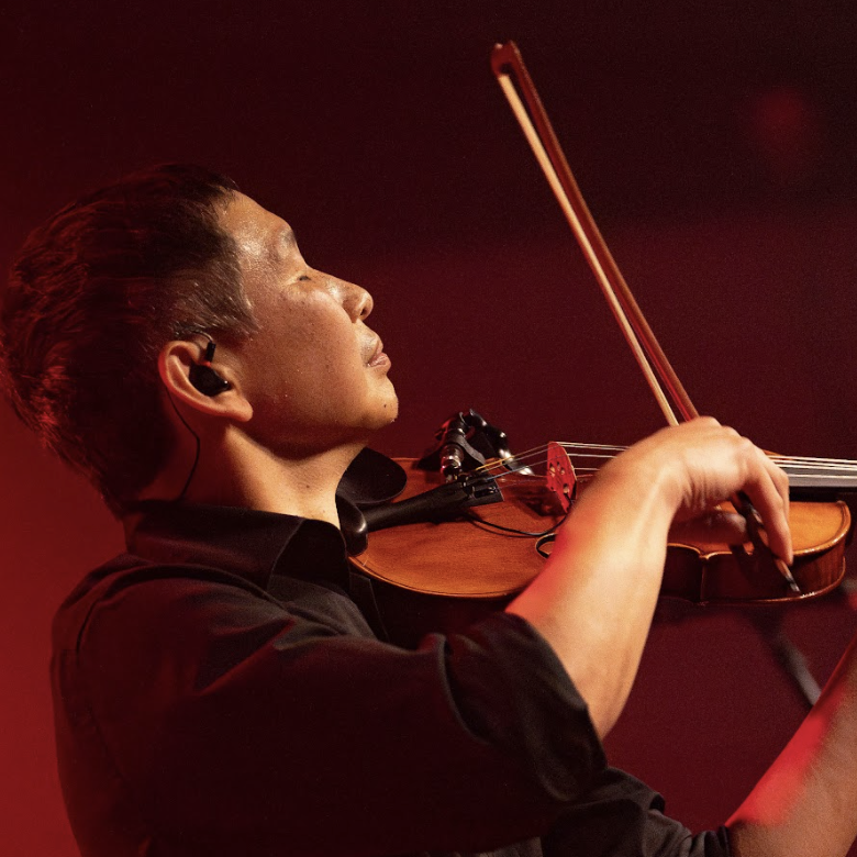 Abe dewing playing violin in Boston