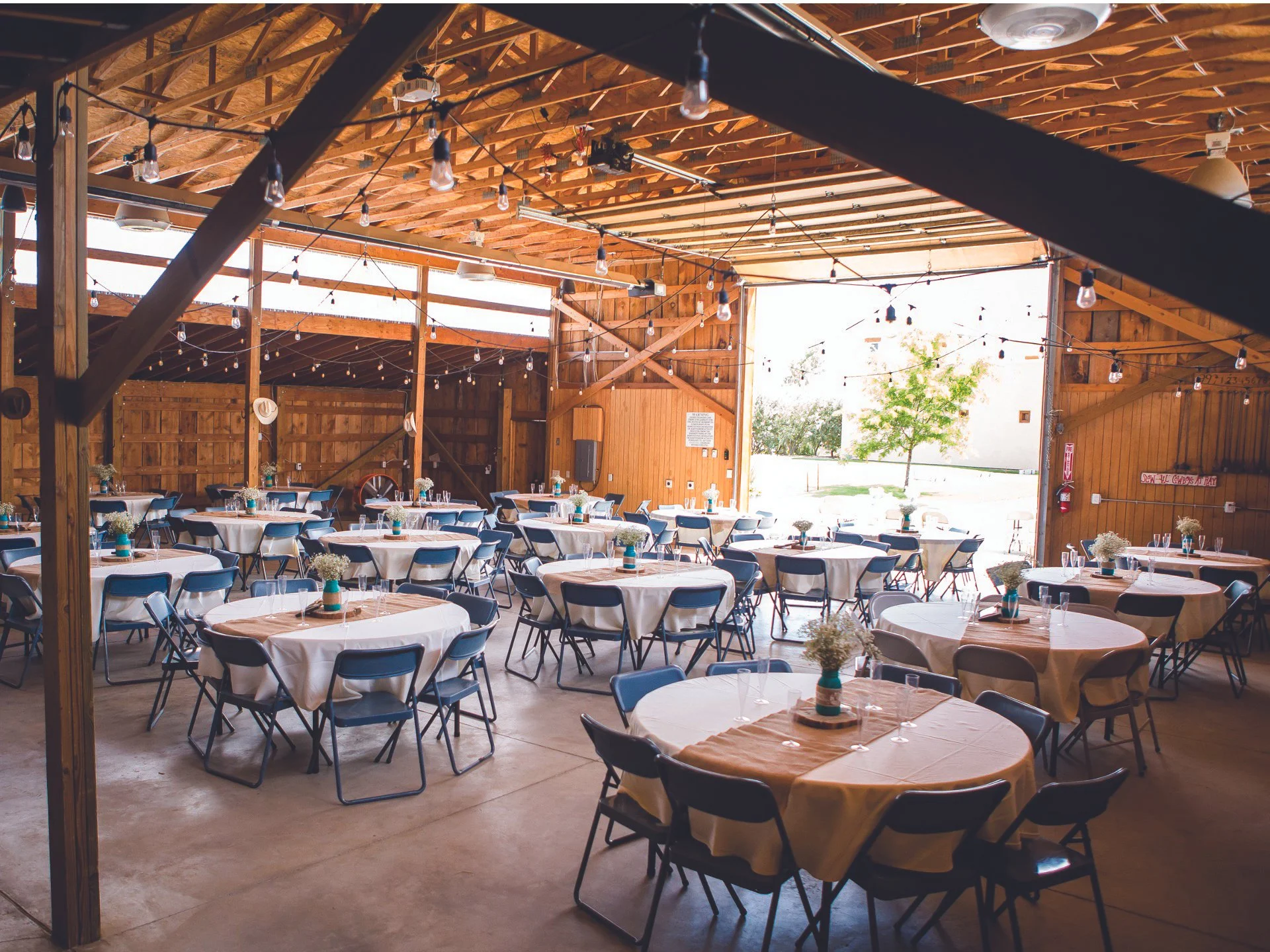 Rustic indoor event venue at River Fort Ranch in Northern Colorado, featuring wood-beam architecture, warm ambient lighting, and a spacious, flexible layout for private parties and social celebrations.