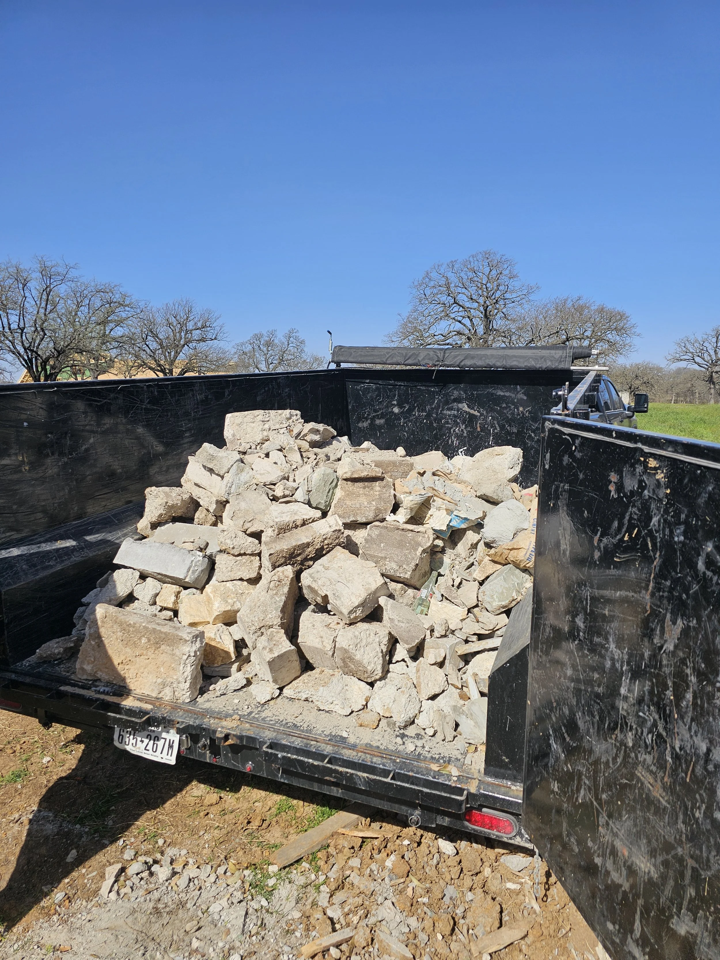 Yellow Rose Junk Removal Trailer getting rid of a large load of concrete.