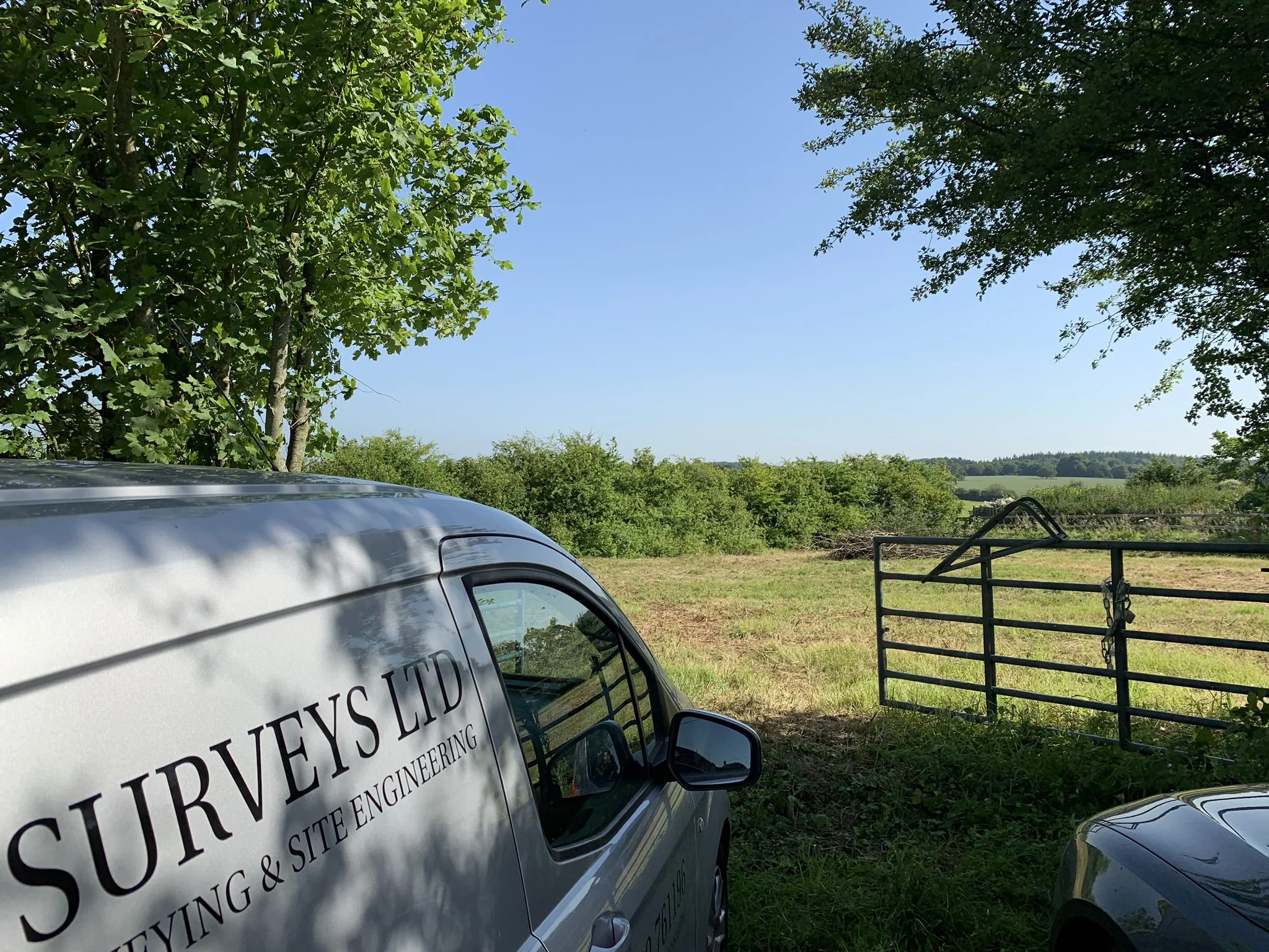 Survey company vehicle beside the entrance to the Hill Top House self-build site in Dummer, Hampshire.