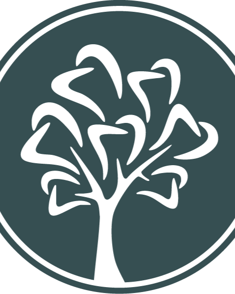 Smiling woman with long hair and a nose ring, wearing a black outfit, against a beige background.