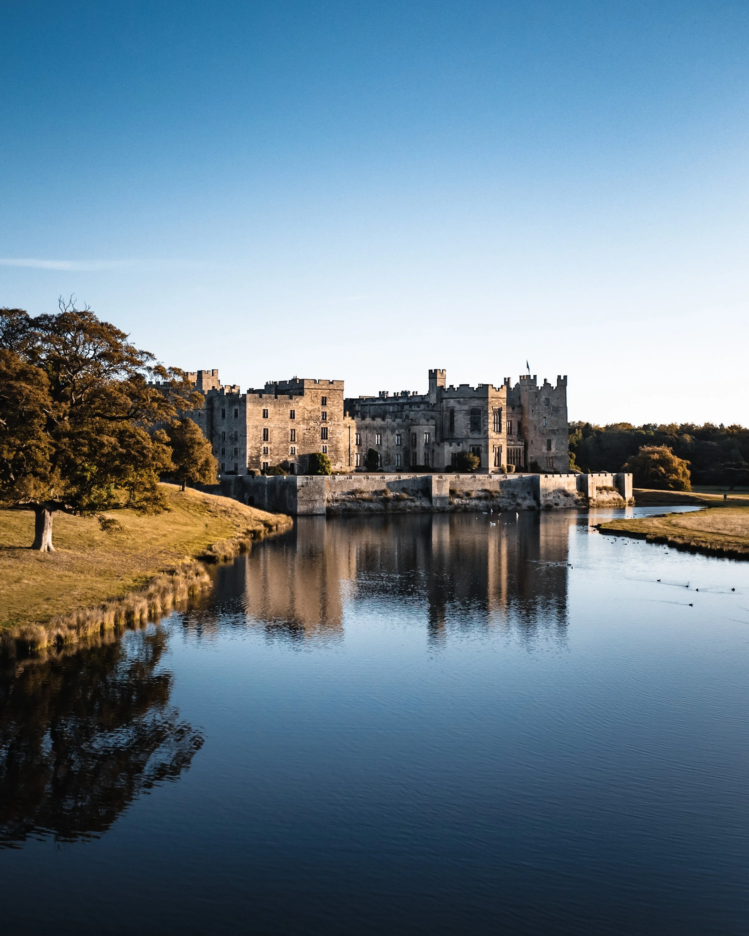 Historic castle surrounded by water and trees