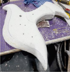 The polystyrene version of the axe head that is to be used to create the mould.