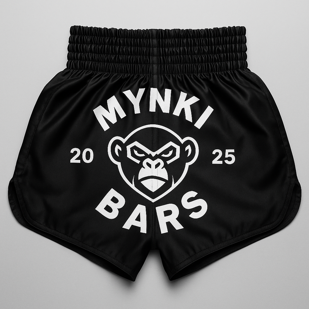 Black shorts with an elastic waistband, featuring a white graphic of a gorilla face and the text 'MYNKI BARS 2025' around the graphic.