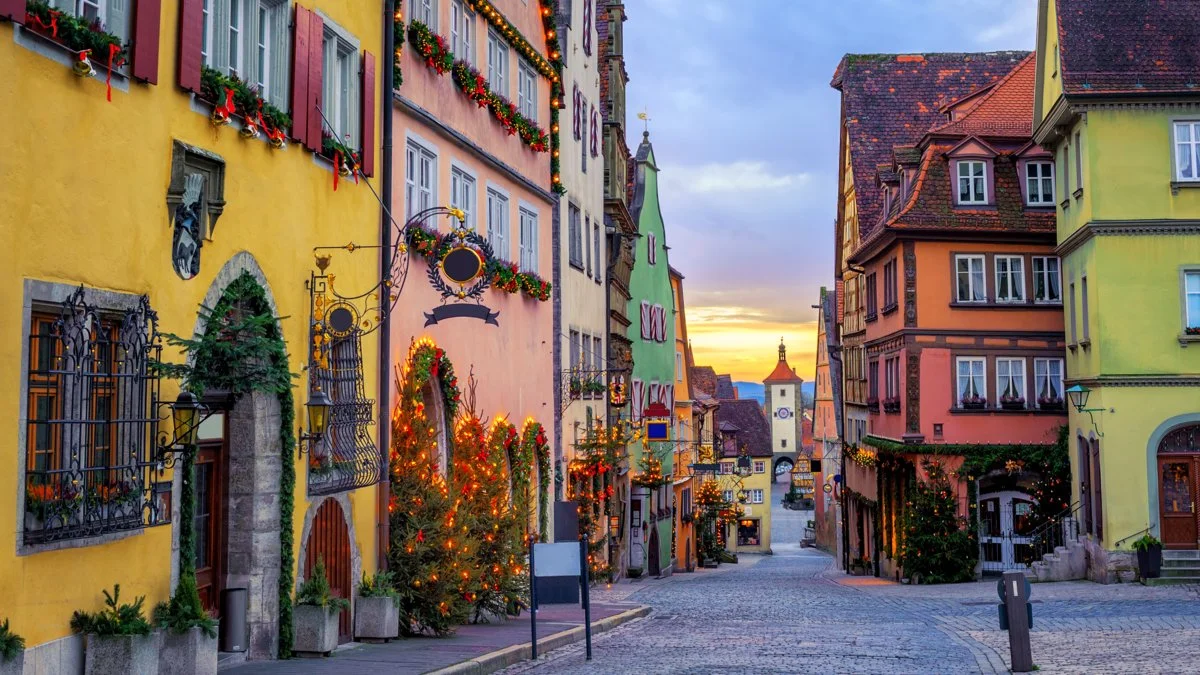 Quaint street in Europe with colorful buildings decorated for Christmas