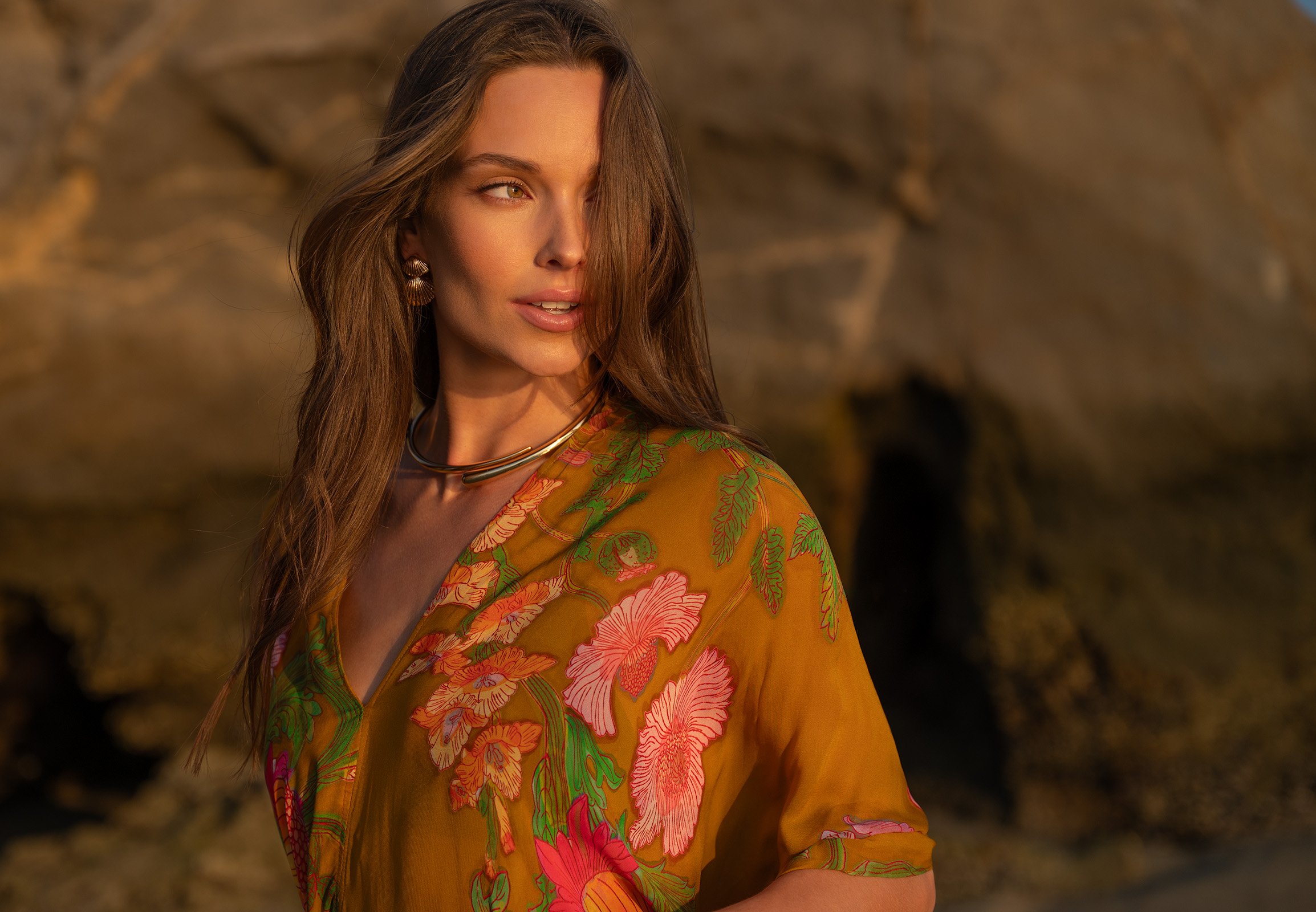 A woman wearing a floral patterned dress in warm tones. Photography by Kelly Fajack. Best photographer in Los Angeles. Capturing travel, fashion, and advertising. Fashion in Los Angeles. Fashion, resort, luxury lifestyle photographer.