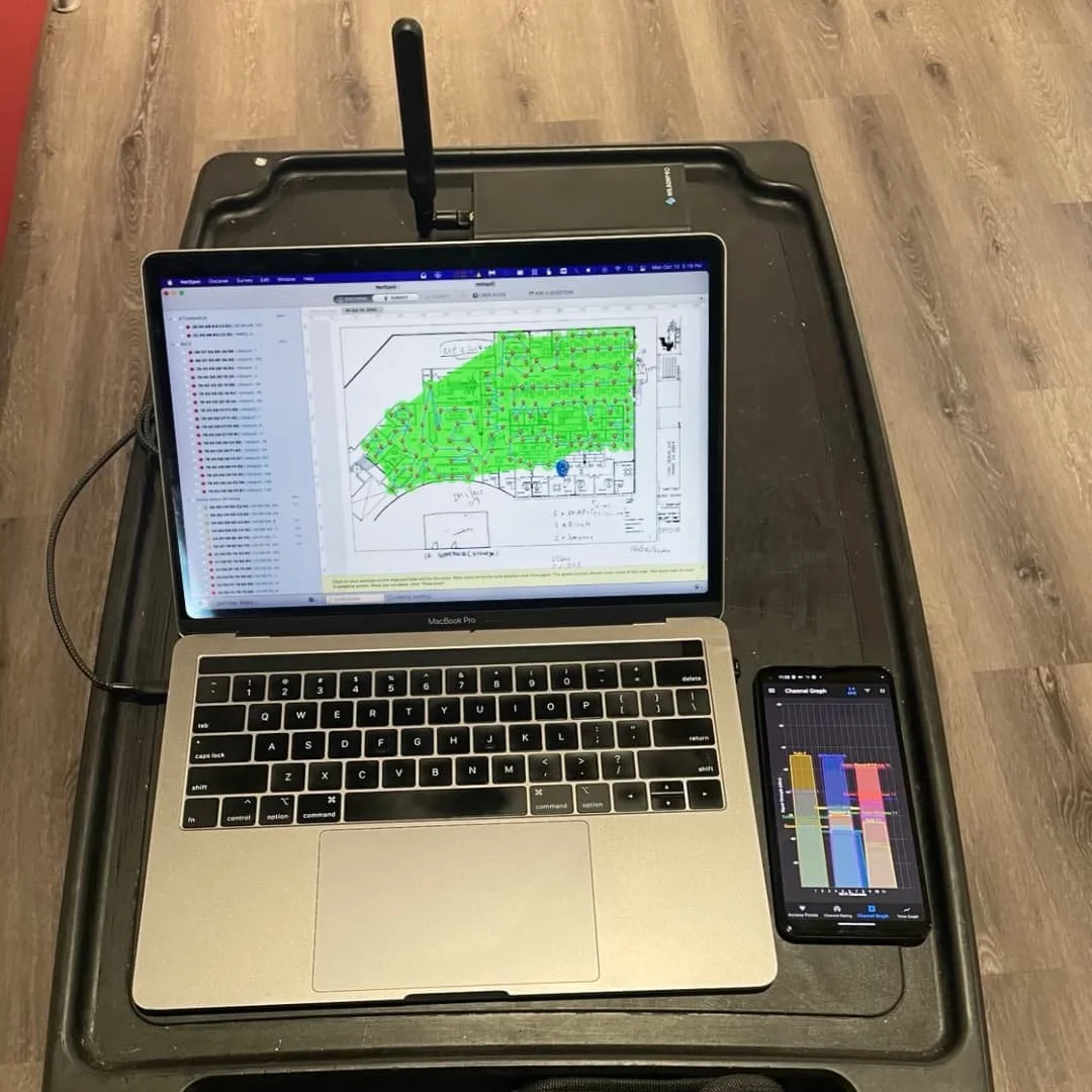 Laptop and phone collecting Wi-Fi and cellular survey data in Irvine, CA.