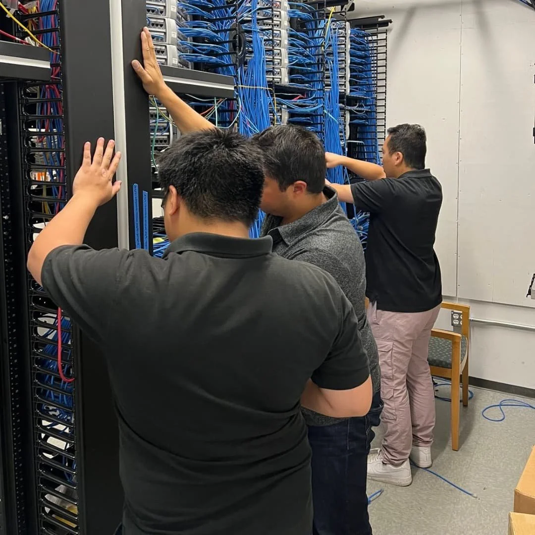 Technicians installing network switches in a server rack in Burbank, CA.