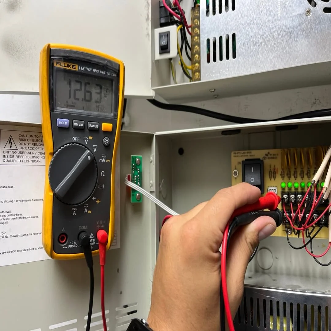 Technician testing a power supply with a multimeter Los Angeles, CA.