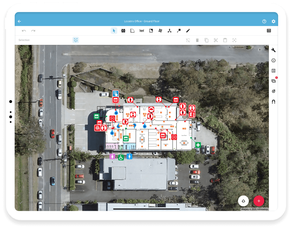 A satellite view of a building floor plan with various safety and medical icons, surrounded by parking lots and trees.