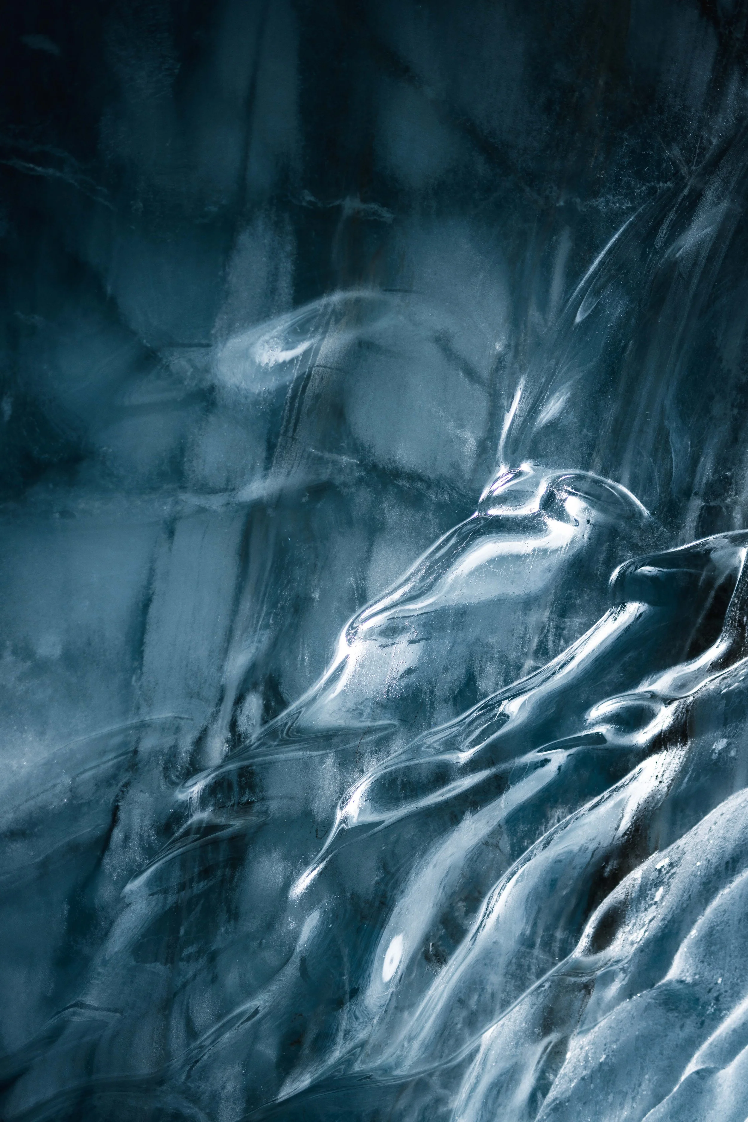 Close-up image of ice with smooth, glossy textures and patterns.