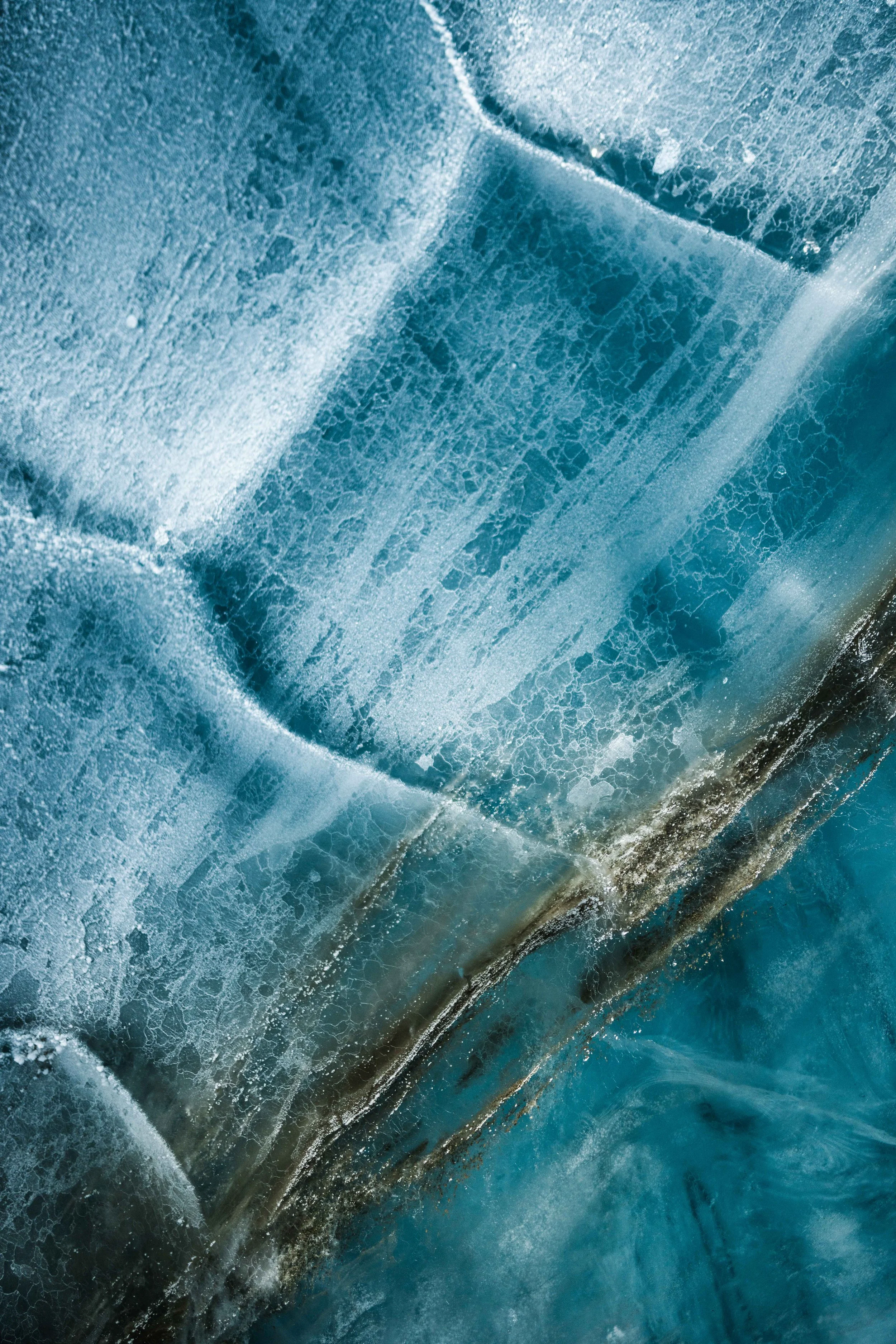 Close-up of frost-covered ice with a textured, cracked surface.