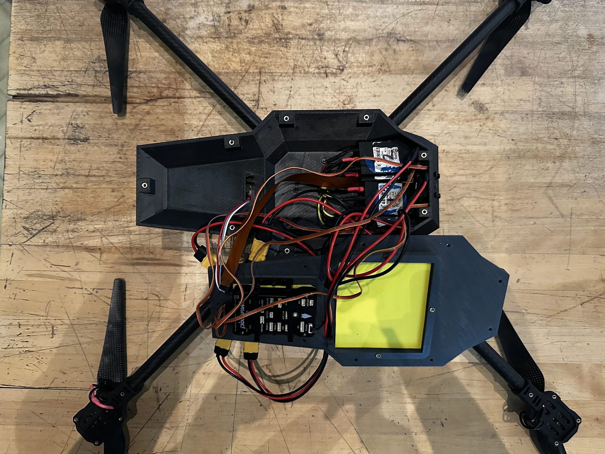  Interior of drone body for initial test runs, prototype voltage distribution board is depicted under the drone. This was later cleaned up in final versions. 