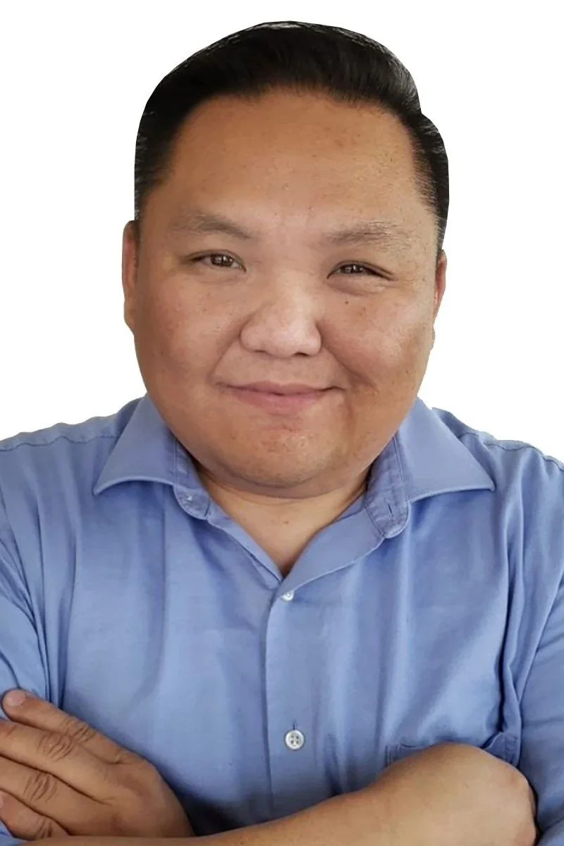 Portrait of an Asian male with black hair wearing a button down shirt with his arms crossed and a smile on his face.