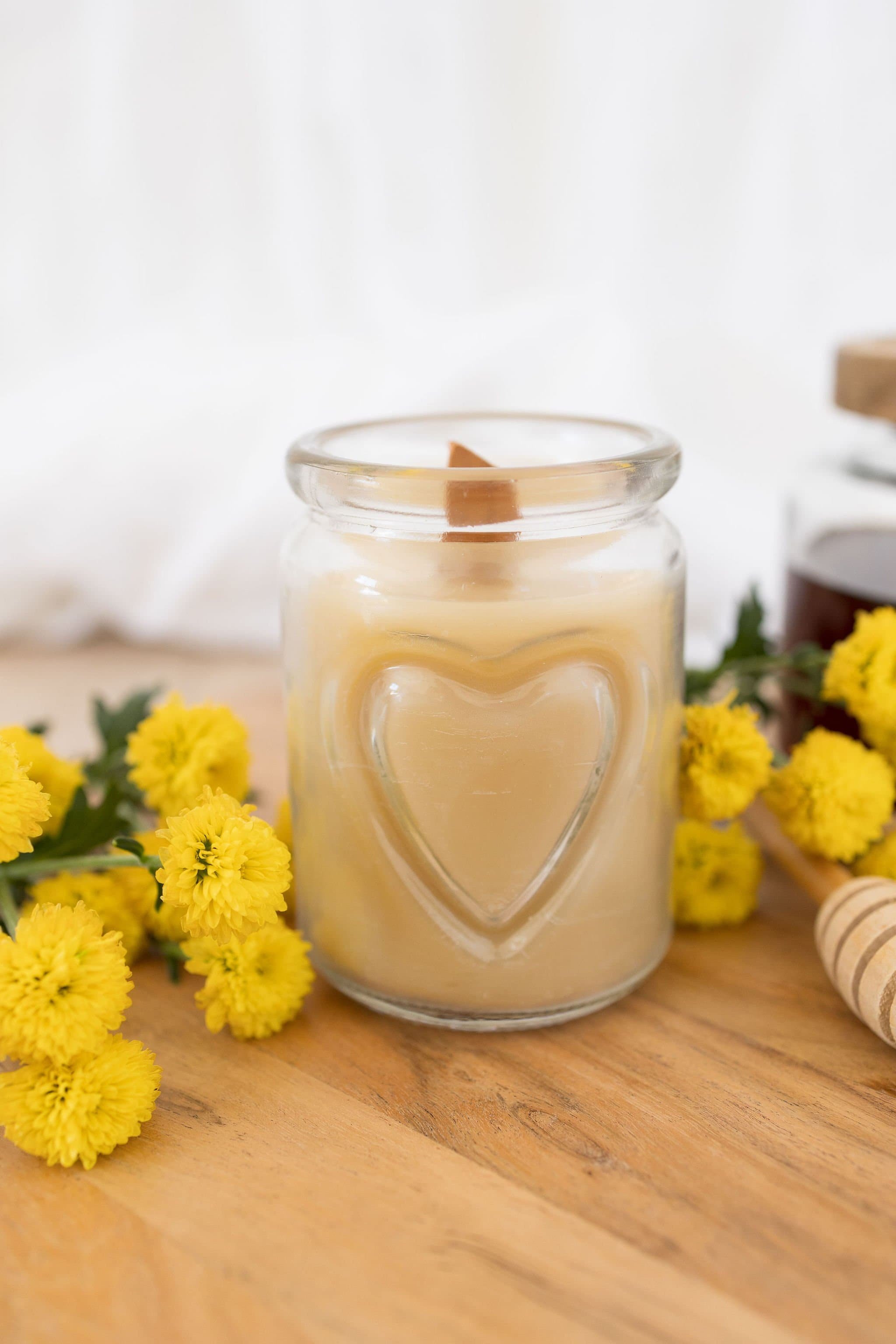 Handmade beeswax candle in a heart design glass with wooden wick, natural eco-luxury gift